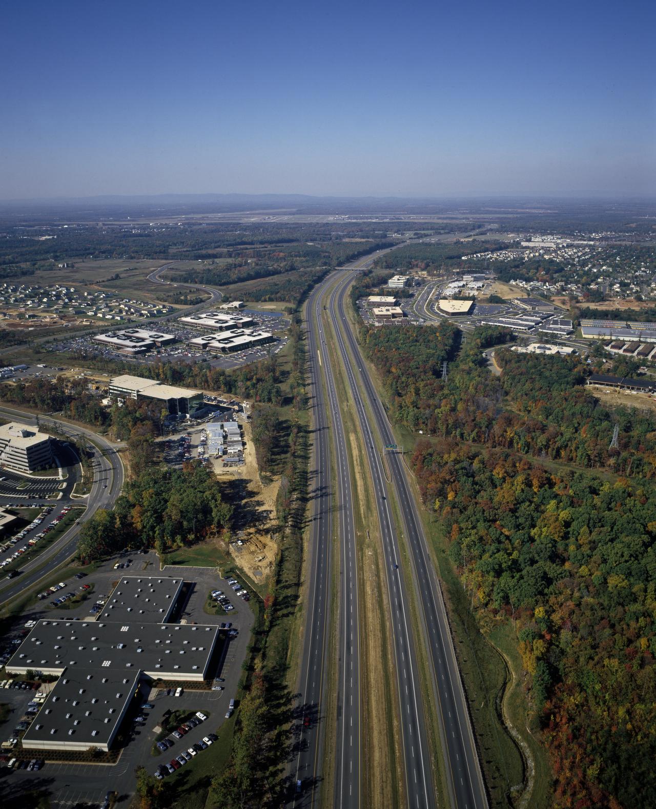 Aerial view of suburban homes in Northern Virginia with Washington D.C. skyline in the distance
