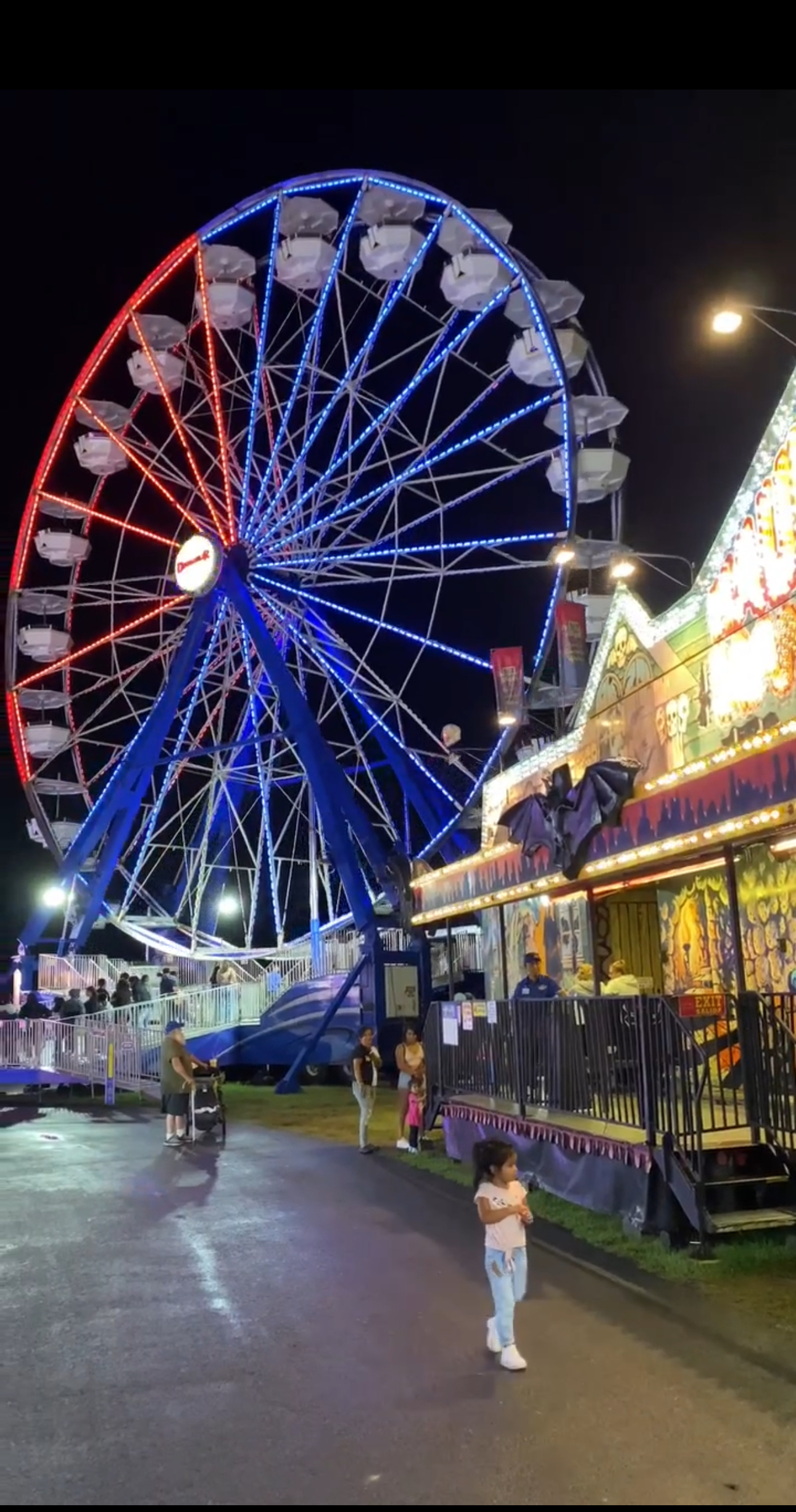 Carnival rides and crowds at the Prince William County Fair in Manassas, Virginia during a summer evening in 2025