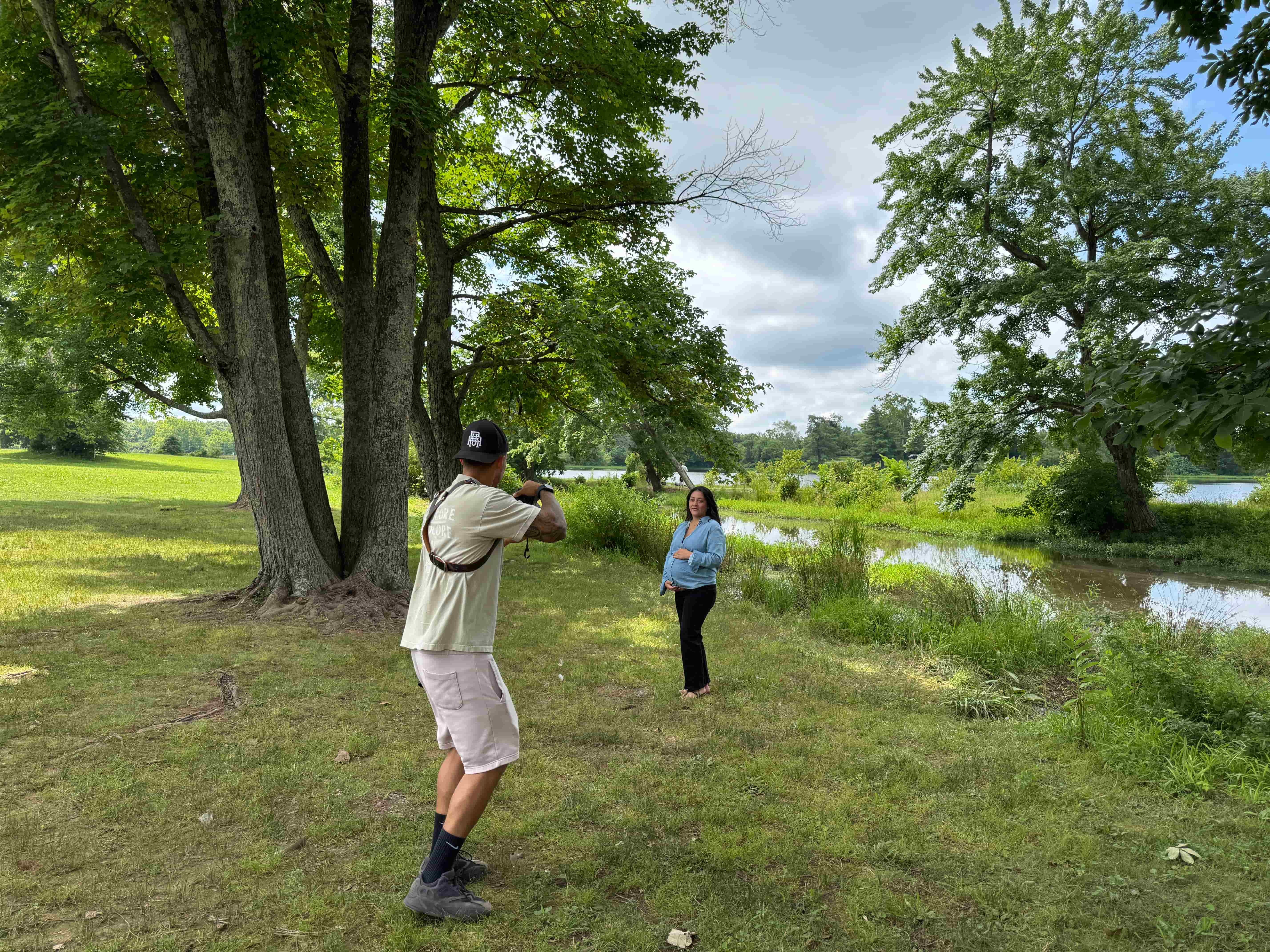 Photographer Bobby Bandz taking a maternity photo of Chris Colgan's wife by the water at Silver Lake Park in Haymarket, VA.