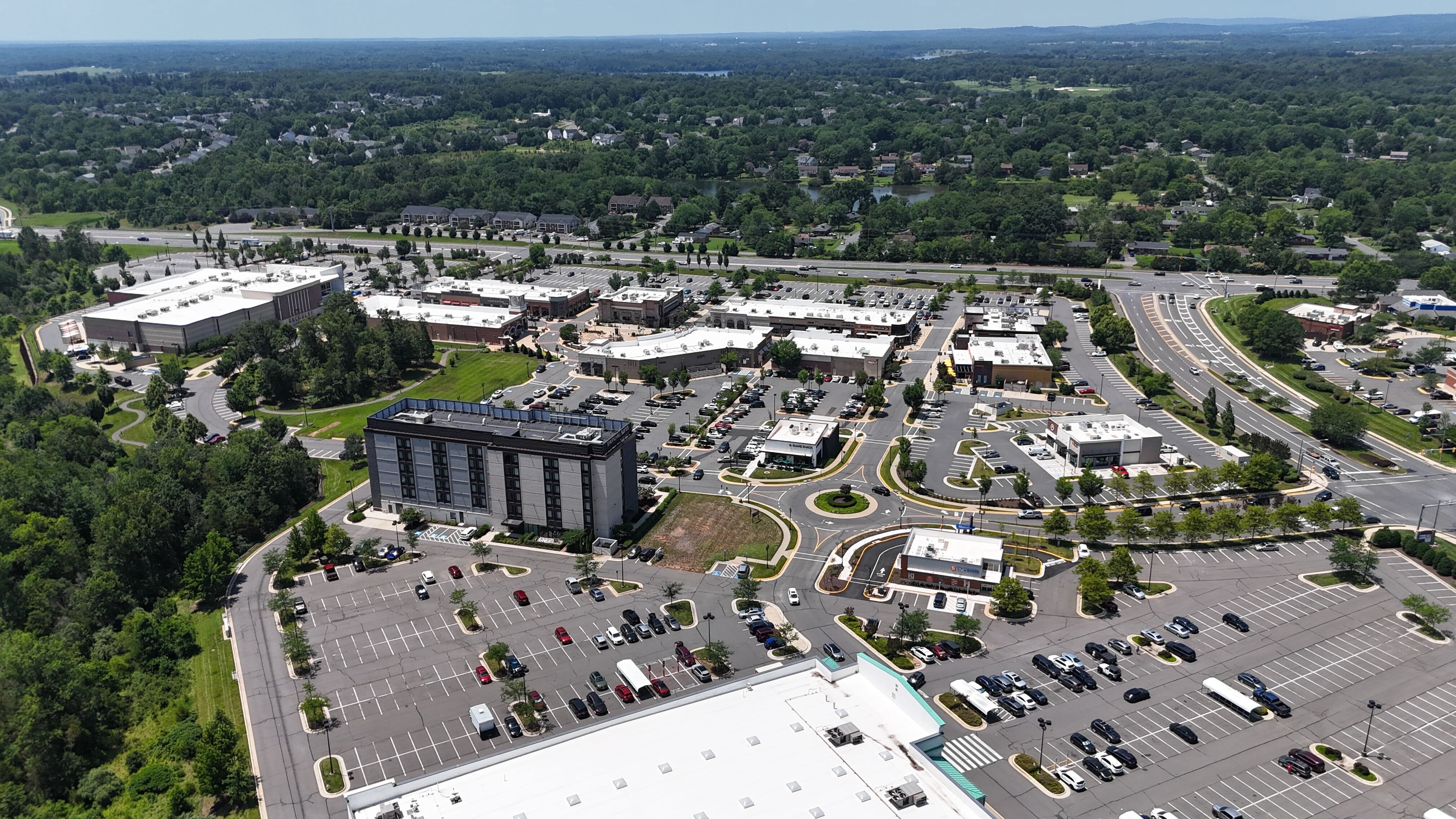 A wide aerial view of the Virginia Gateway shopping center in Gainesville, Virginia, showing the Target, a hotel, and other retail stores.
