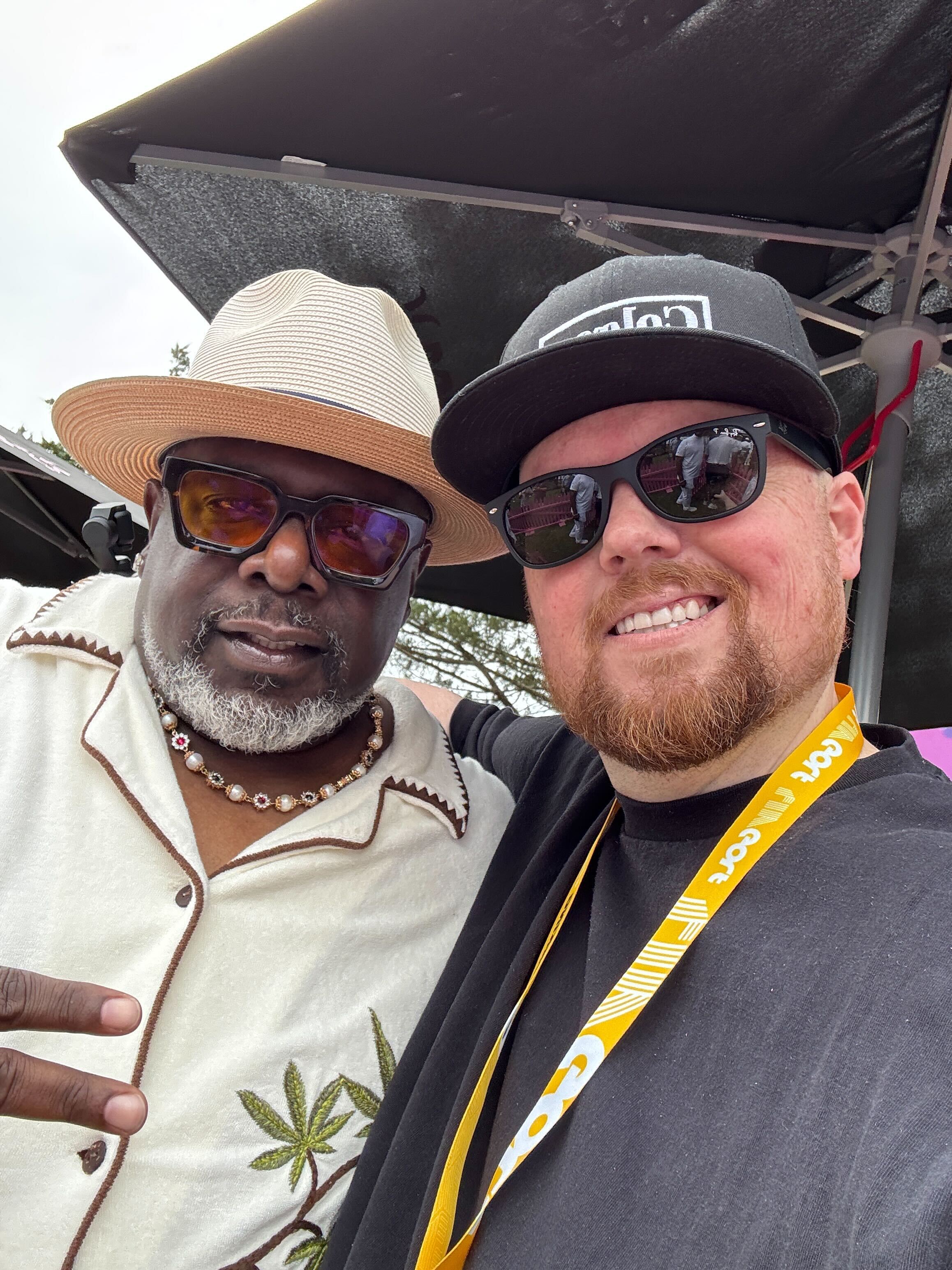 Realtor Chris Colgan takes a selfie with comedian and actor Cedric the Entertainer at the LIV Golf tournament at Lake Manassas in Gainesville, Virginia.