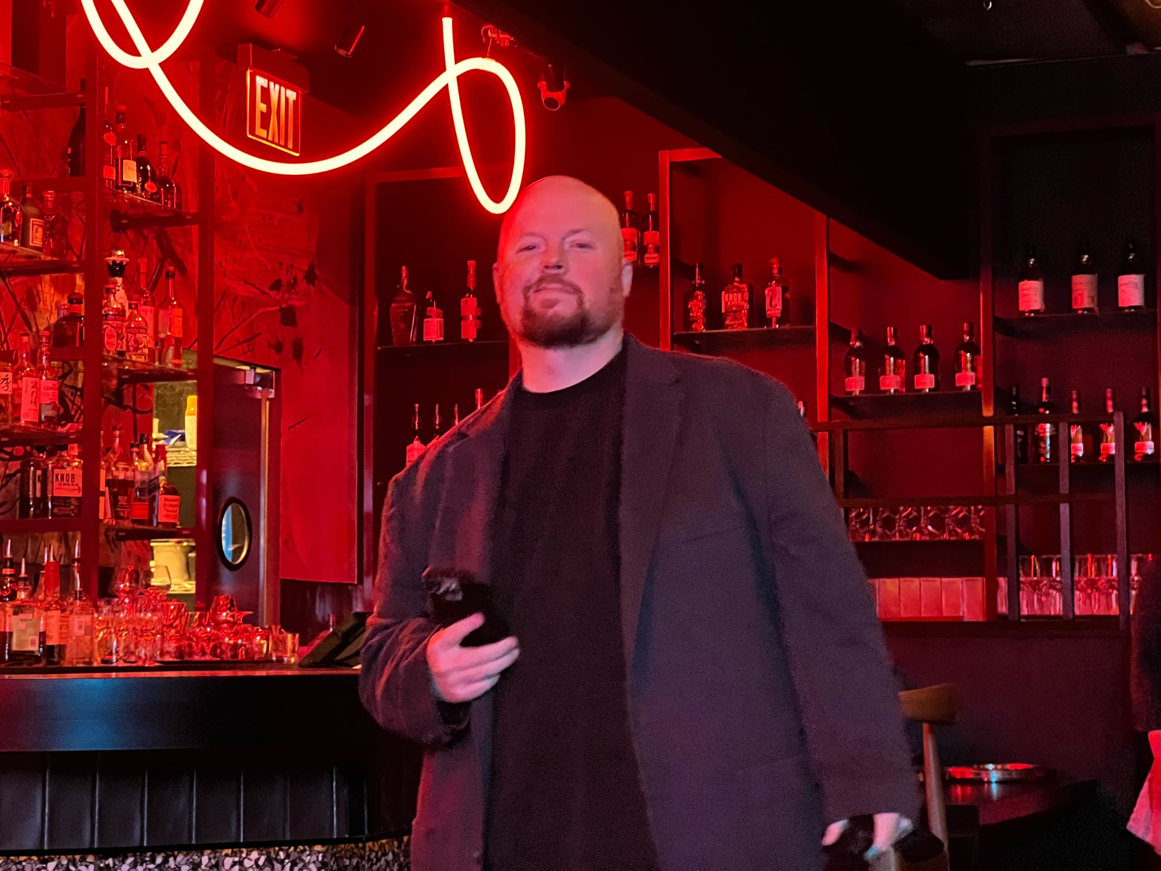 Chris Colgan attending an invite-only night at the Naisō Room, an exclusive Japanese-inspired speakeasy in Tysons, VA, with signature red mood lighting.