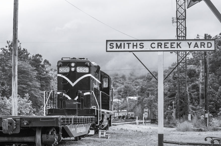Black and white collage of Vienna, Burke, and Clifton, VA showing a historic red caboose, a leafy suburban street, and a preserved village main street—symbolizing Northern Virginia’s evolution from railroad towns to commuter suburbs.