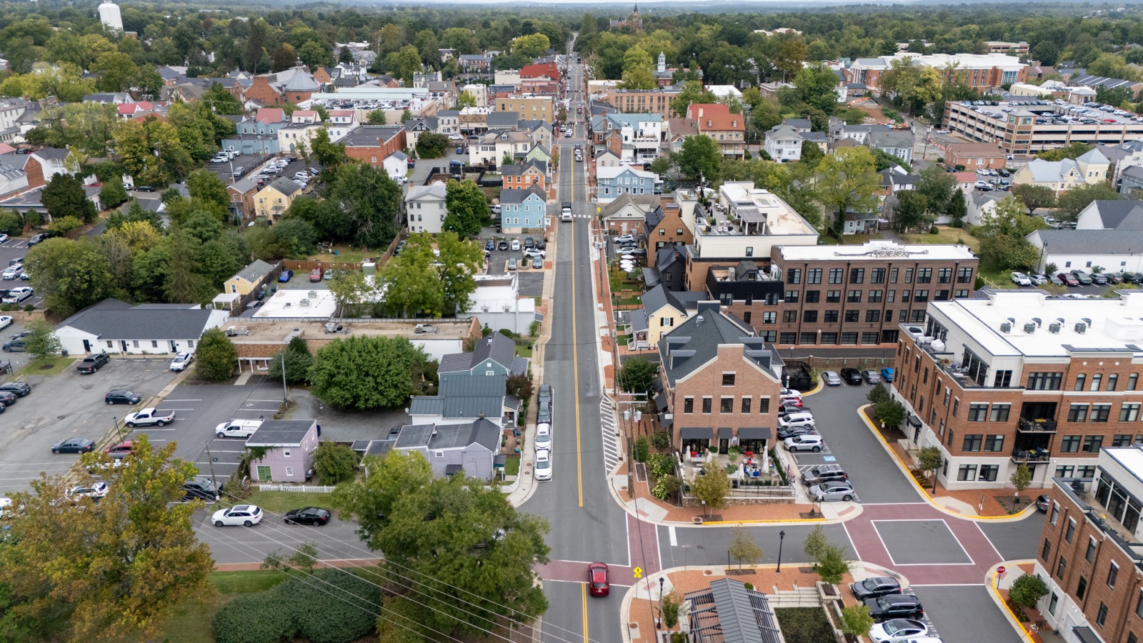 Aerial view along a downtown Leesburg street with homes, shops, and crosswalks