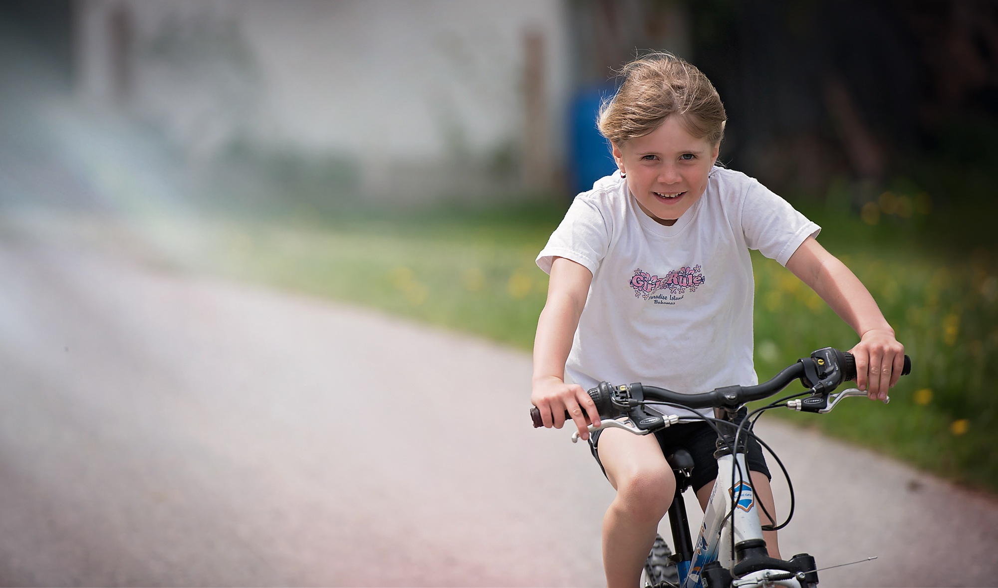 young girl riding bike in the summer