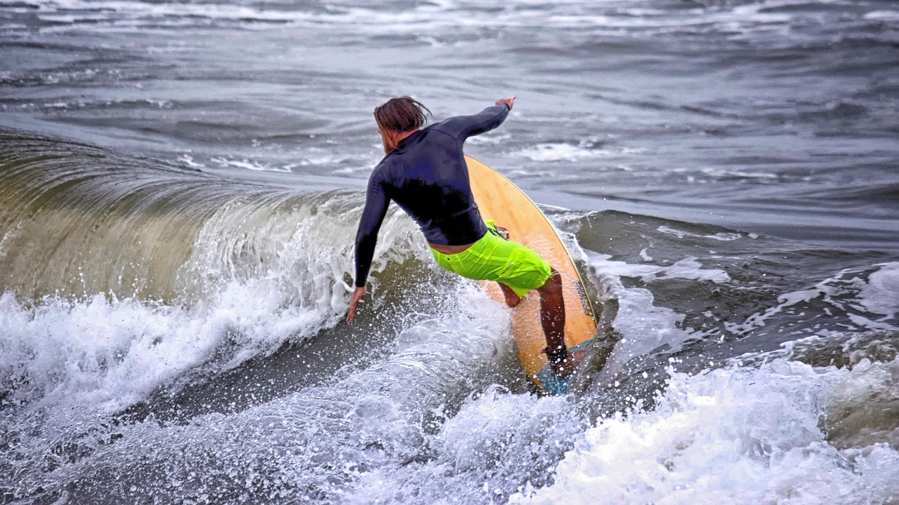 surfer catches wave on north carolina coast