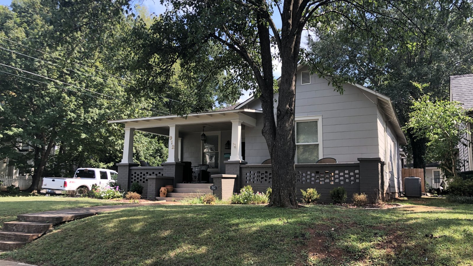 Craftsman bungalow with a deep front porch on a shaded street in the Five Points neighborhood of Huntsville, Alabama