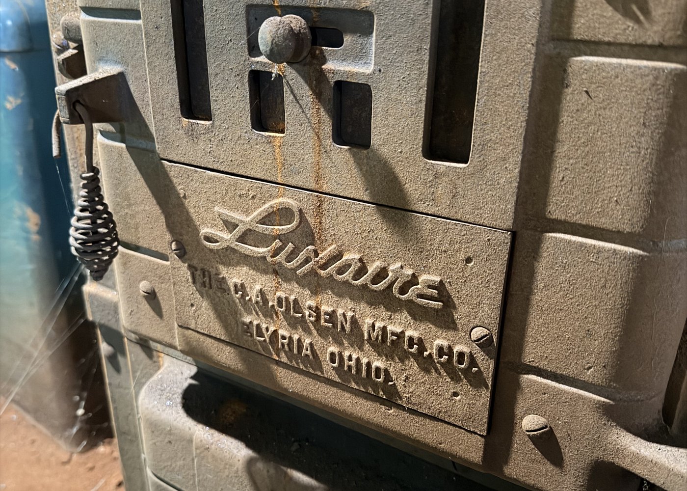 A 1950s Luxaire furnace nameplate in the crawlspace of a Huntsville, Alabama home