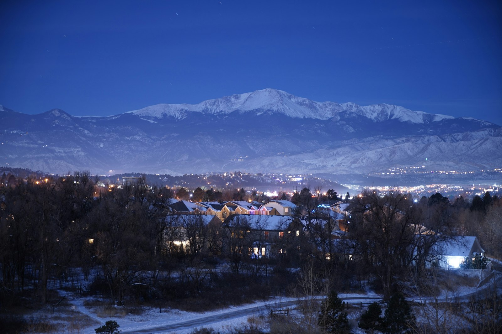 Colorado Springs, Colorado at dusk below snow-covered Pikes Peak, compared with Huntsville, Alabama on cost of living