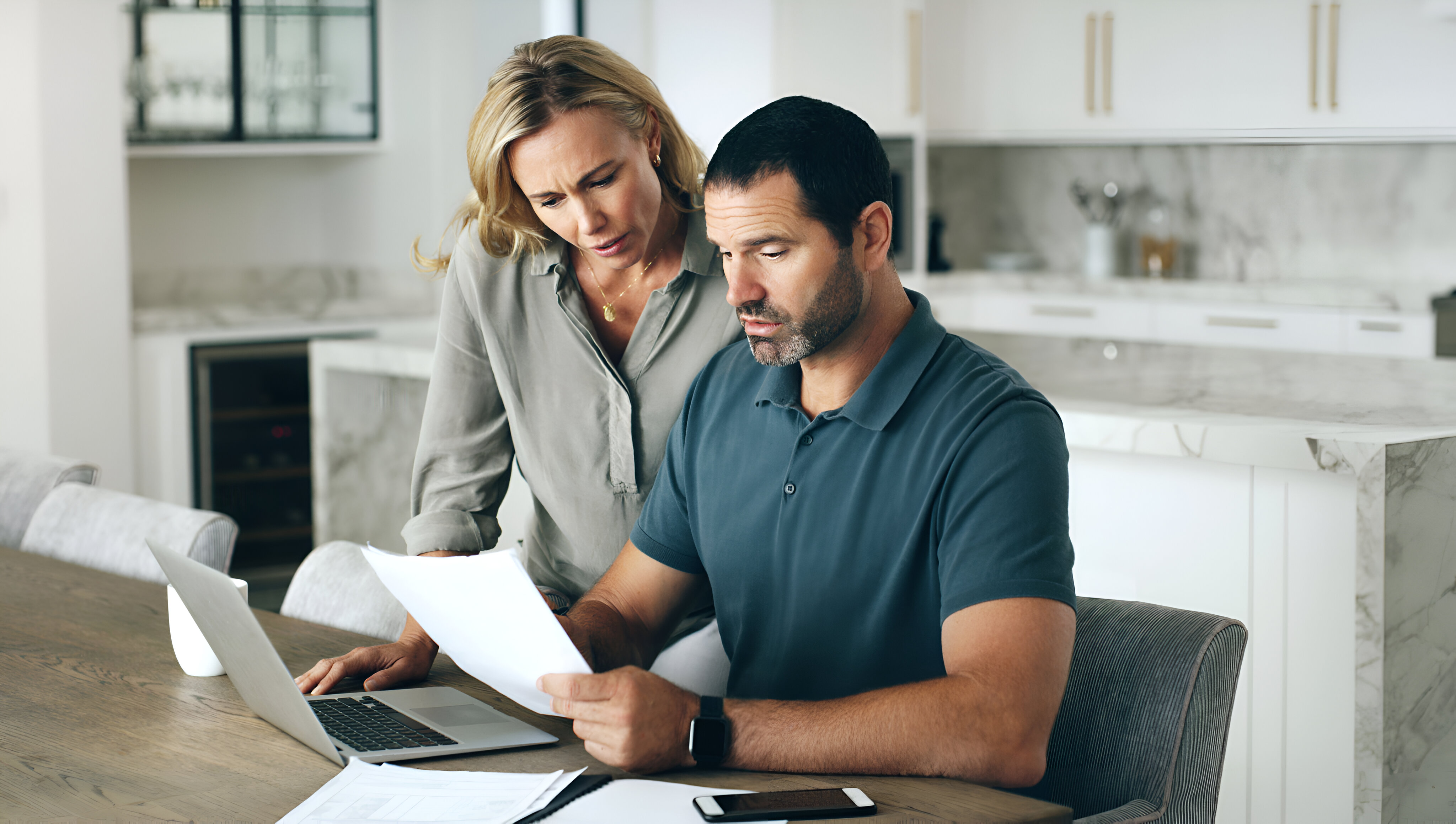 Veteran homebuyers in Oceanside reviewing the VA loan process with a realtor before purchasing their first home.