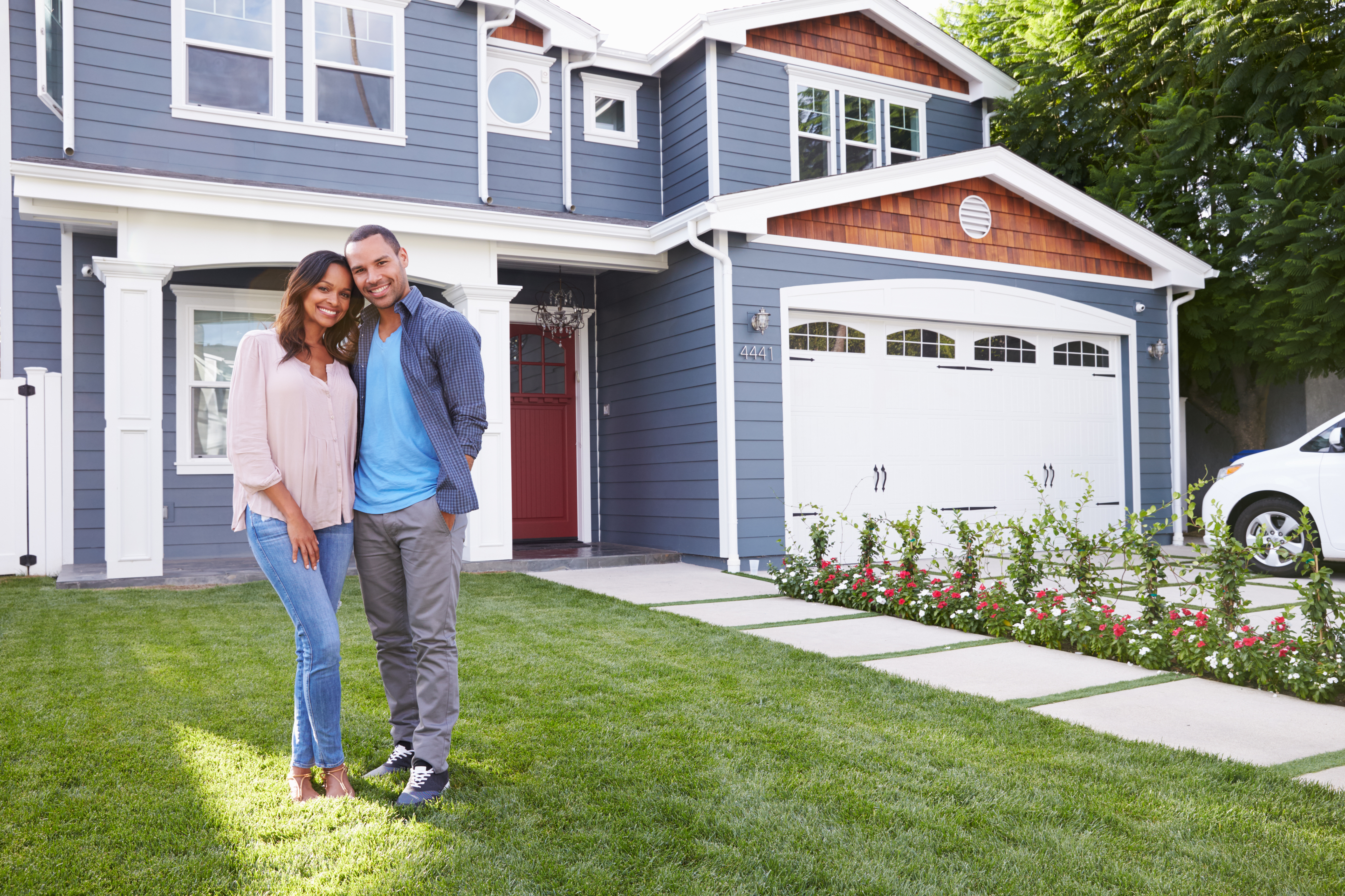 Modern family home with attractive curb appeal and for sale sign.
