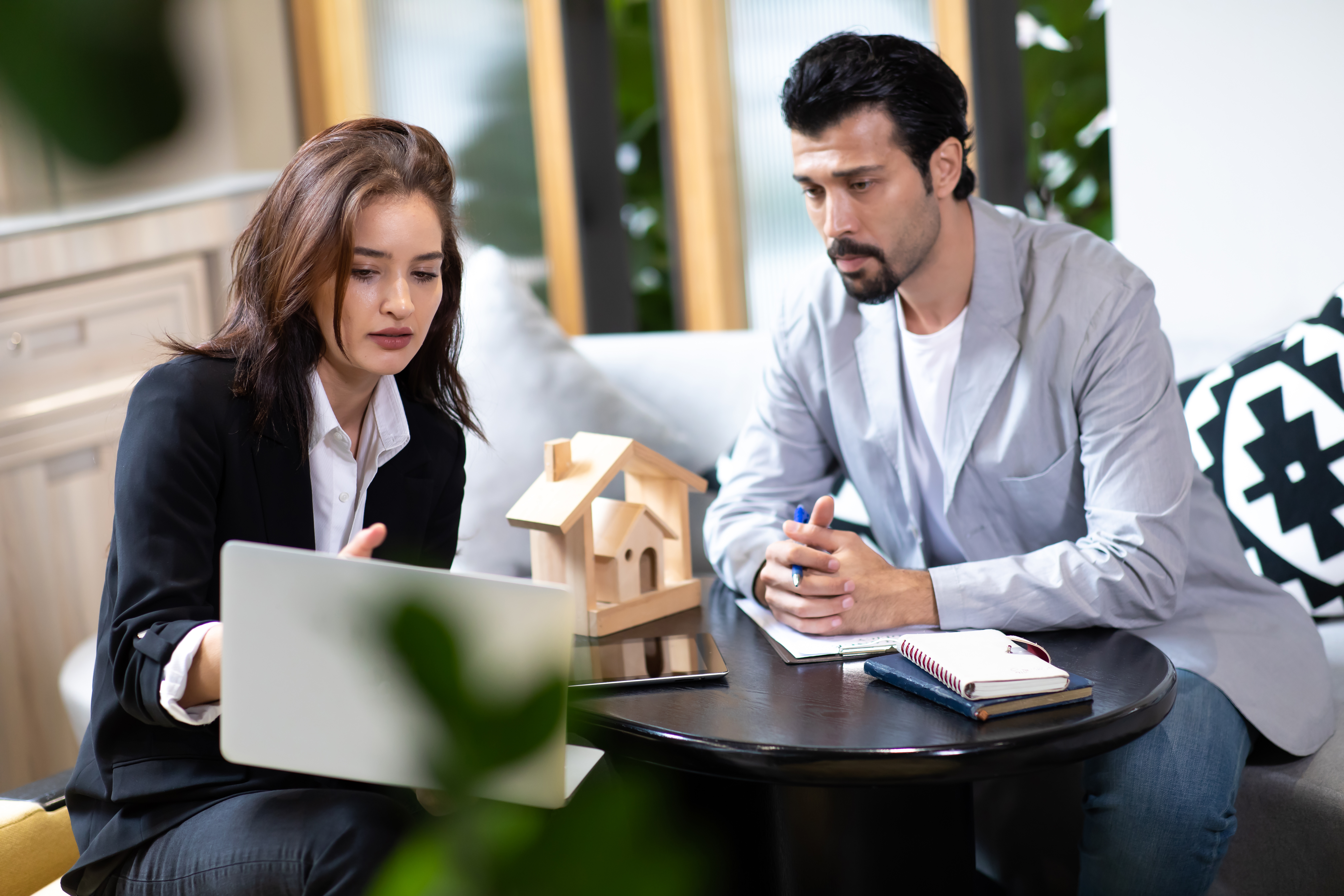 San Diego home seller reviewing offers with a realtor to avoid negotiation mistakes and protect profits.