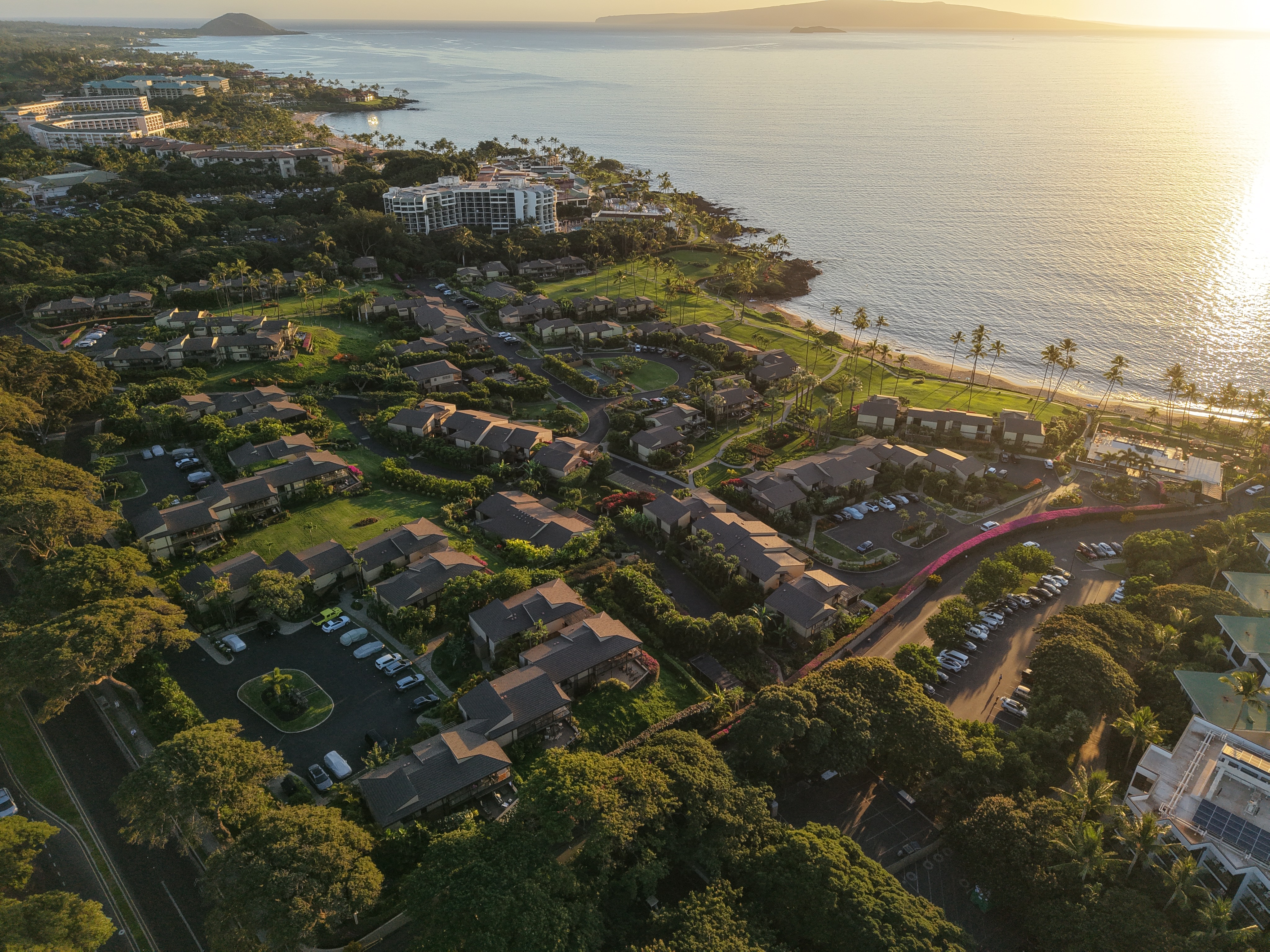 Aerial drone photo of Wailea Elua Village at sunset, overlooking the oceanfront complex and Pacific Ocean, Wailea, Maui