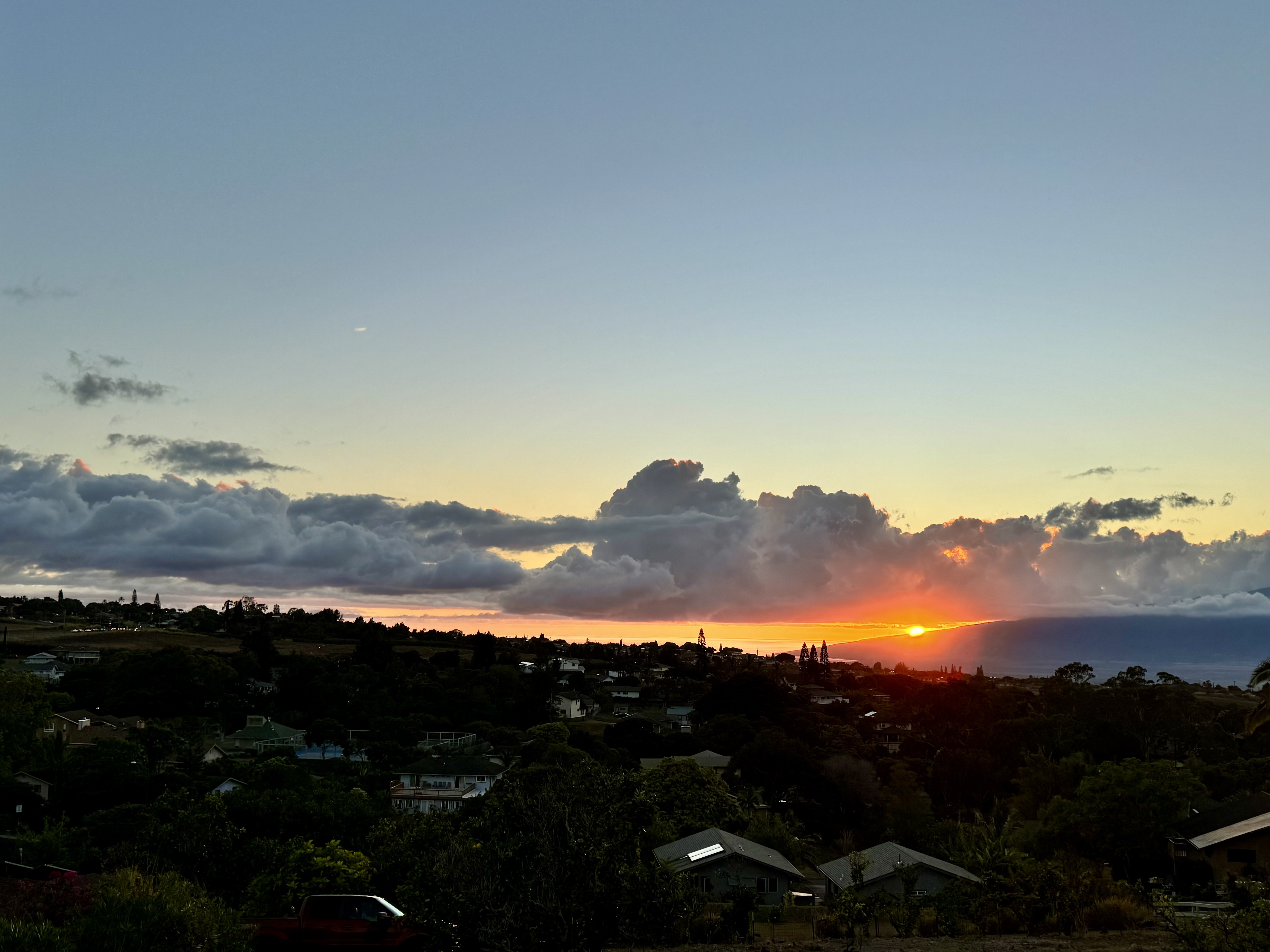 Golden sunset over the Maui coastline, symbolizing the island lifestyle and peaceful transition for those relocating.