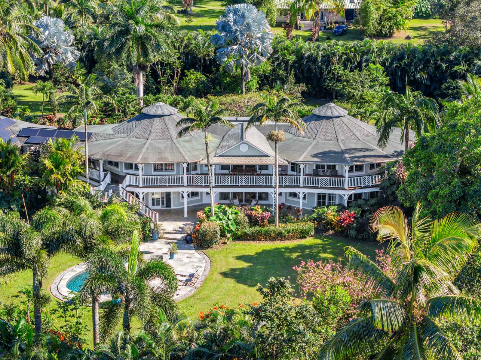 Luxury estate at 65 North Holokai Road in Haiku, Maui featuring ocean views, tropical grounds, a private pool and spa, guest ohana, and over two gated acres on Maui's North Shore.