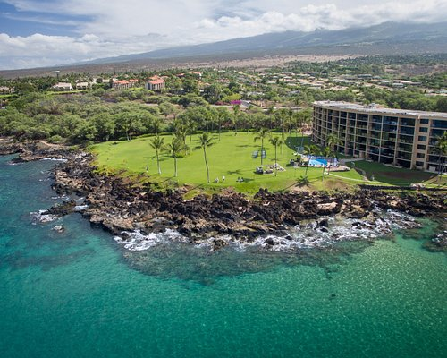Kihei Surfside condos for sale on Keawakapu Beach with oceanfront lawn and panoramic ocean views.