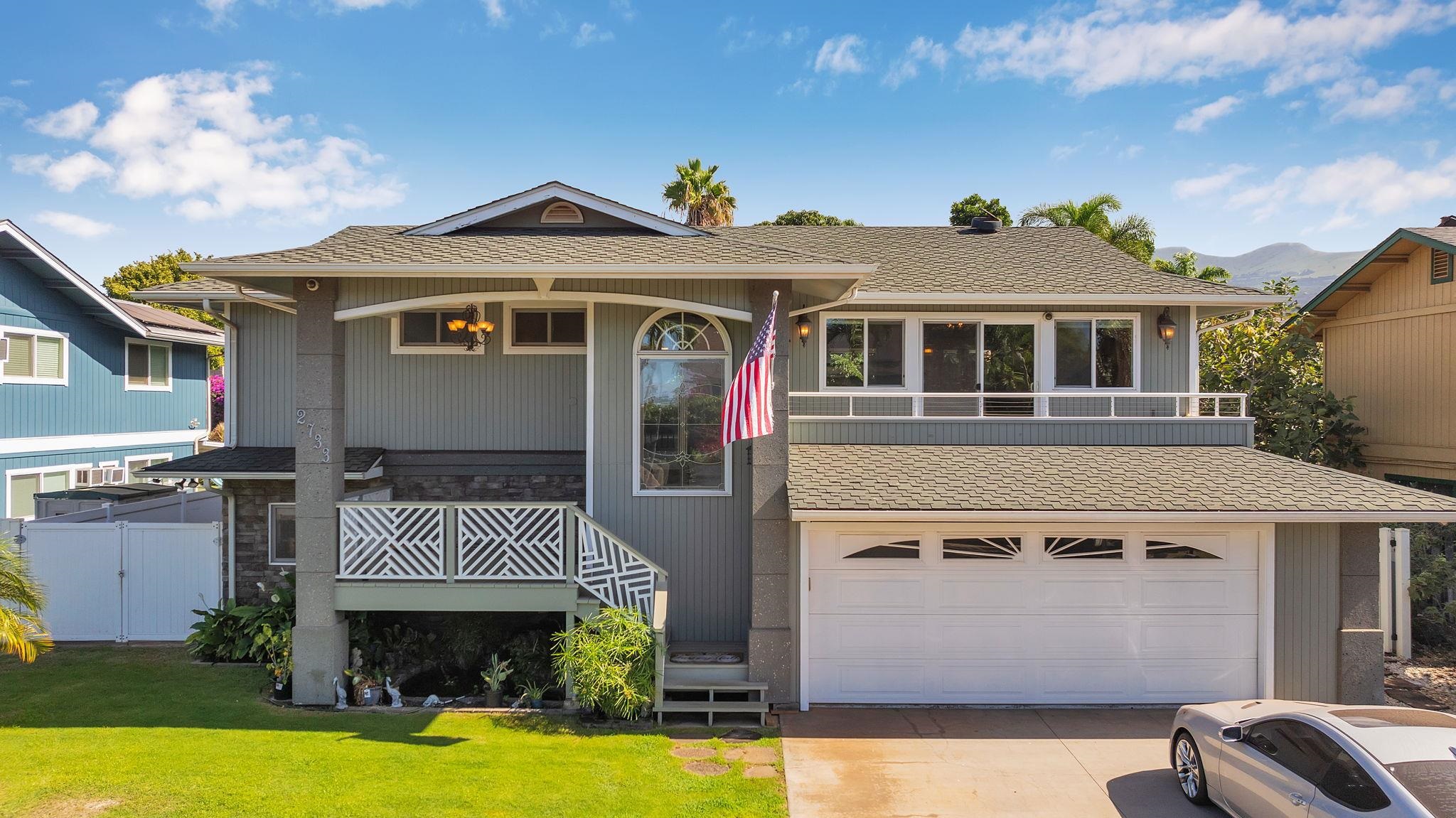 A photo of a single-family home on Maui representing the home buying journey, with clear skies and tropical landscaping.