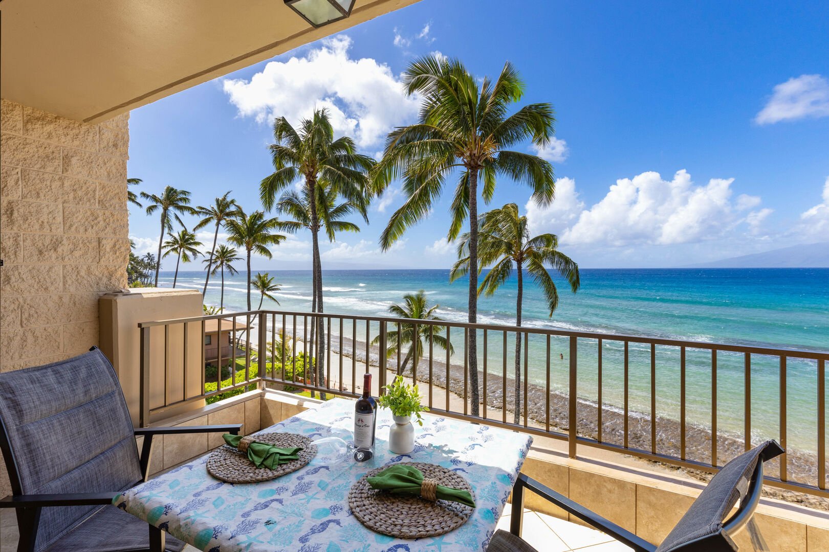Beachfront Maui condo balcony with ocean views, showcasing the relaxed Maui condo lifestyle. 