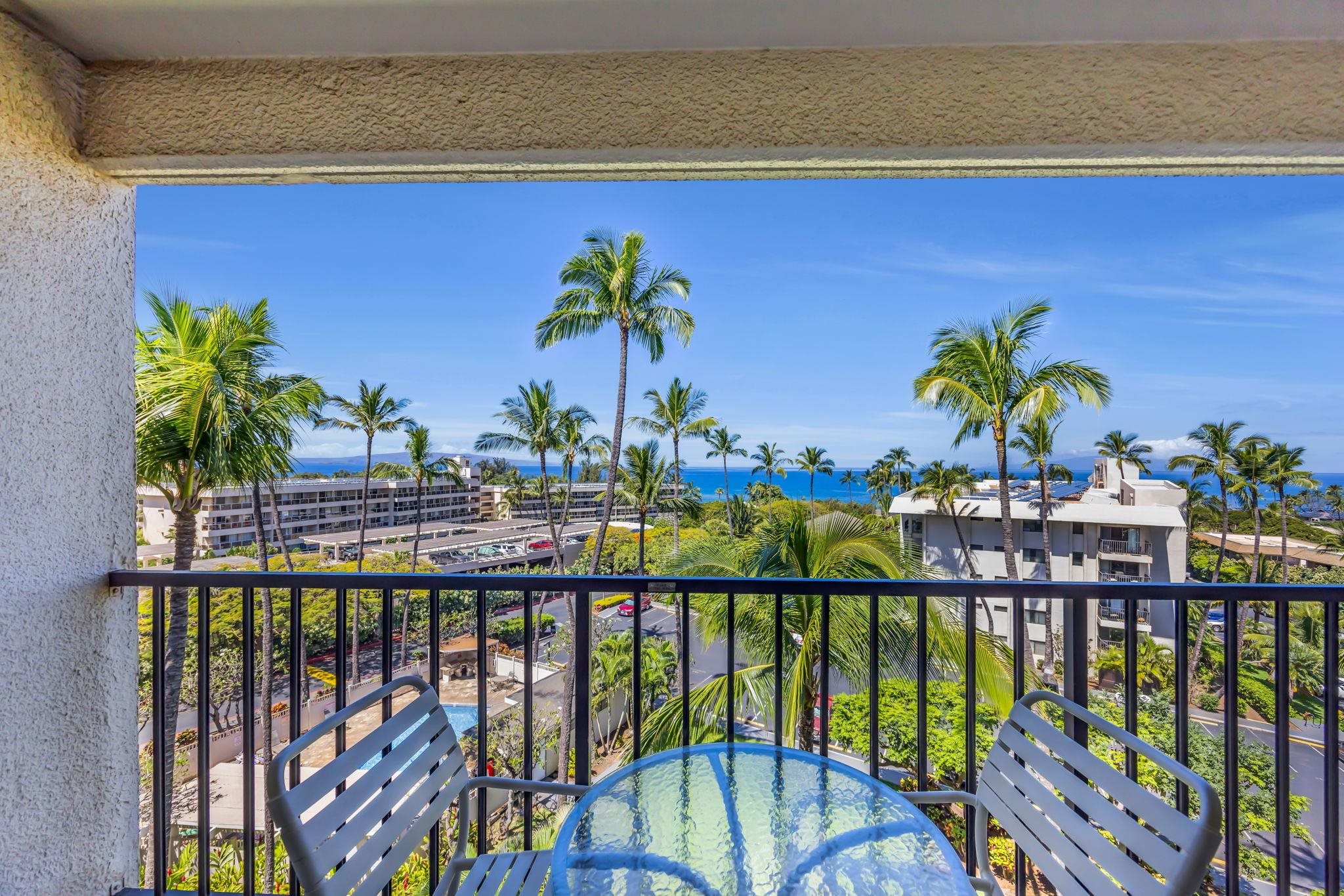 View from the lanai of Kihei Akahi D507, with ocean views and palm trees