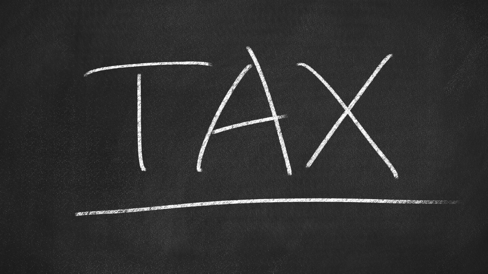 Tax written on a chalk board