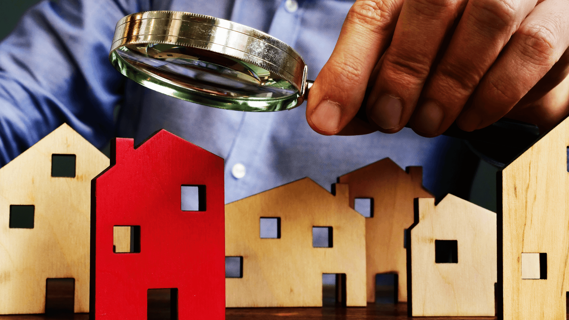 Magnifying Glass over wooden houses