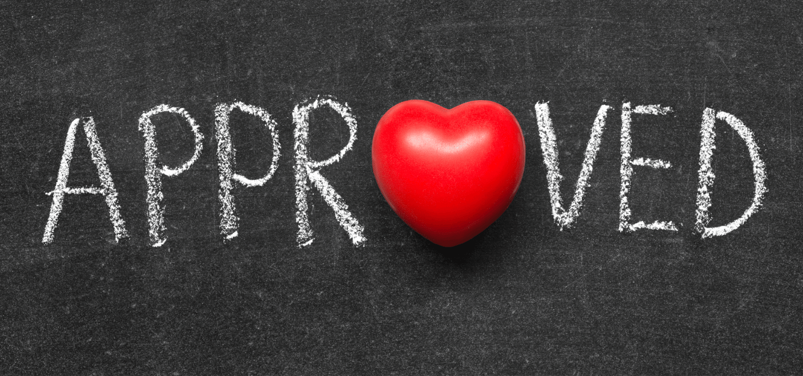 Word approved written in chalk on a blackboard with a red heard for the O
