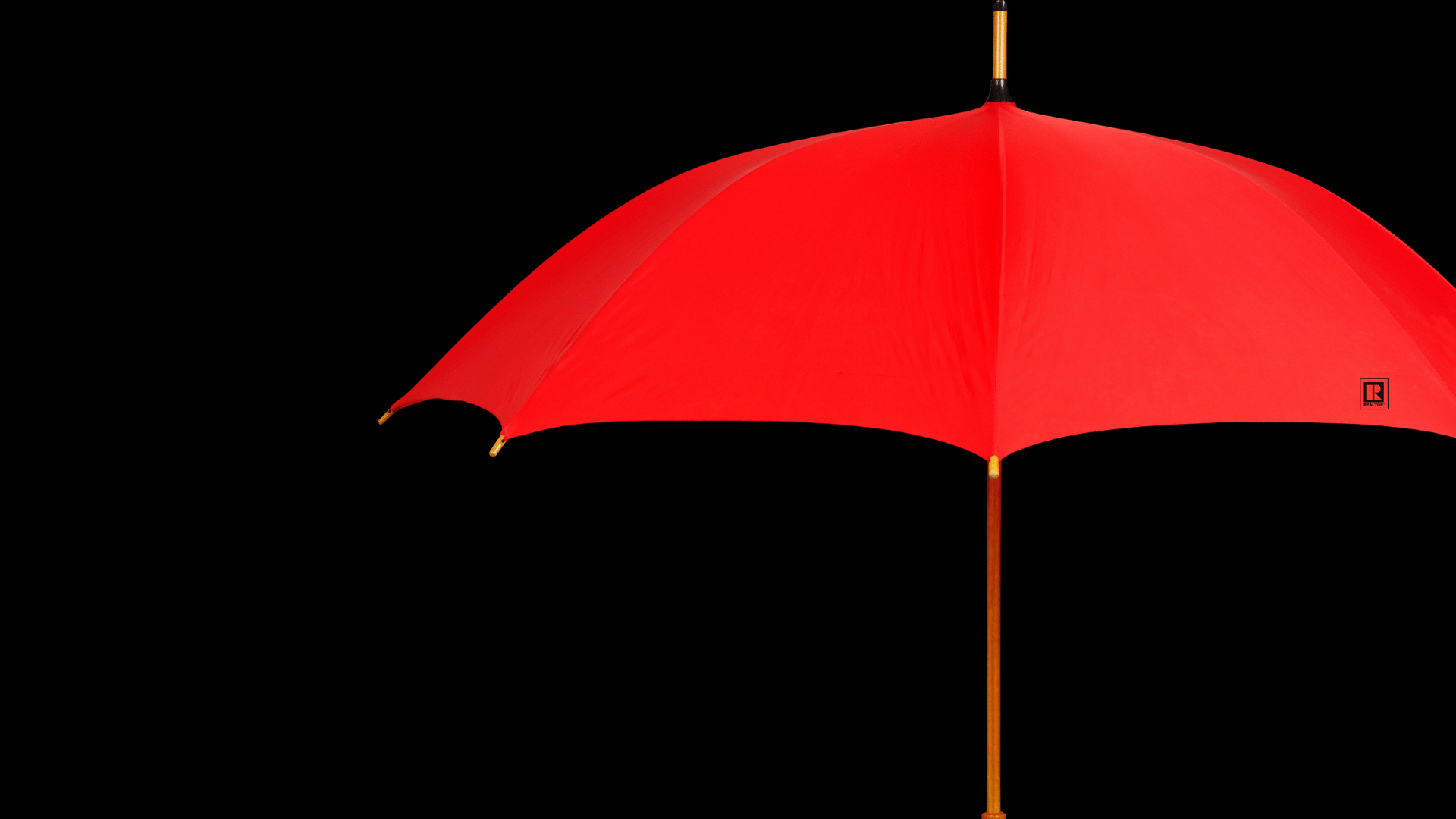 Red umbrella against a black background