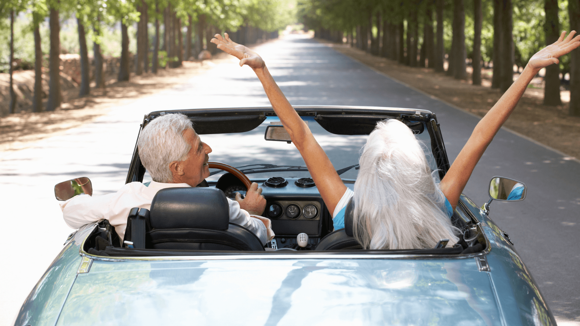 seniors driving in convertible