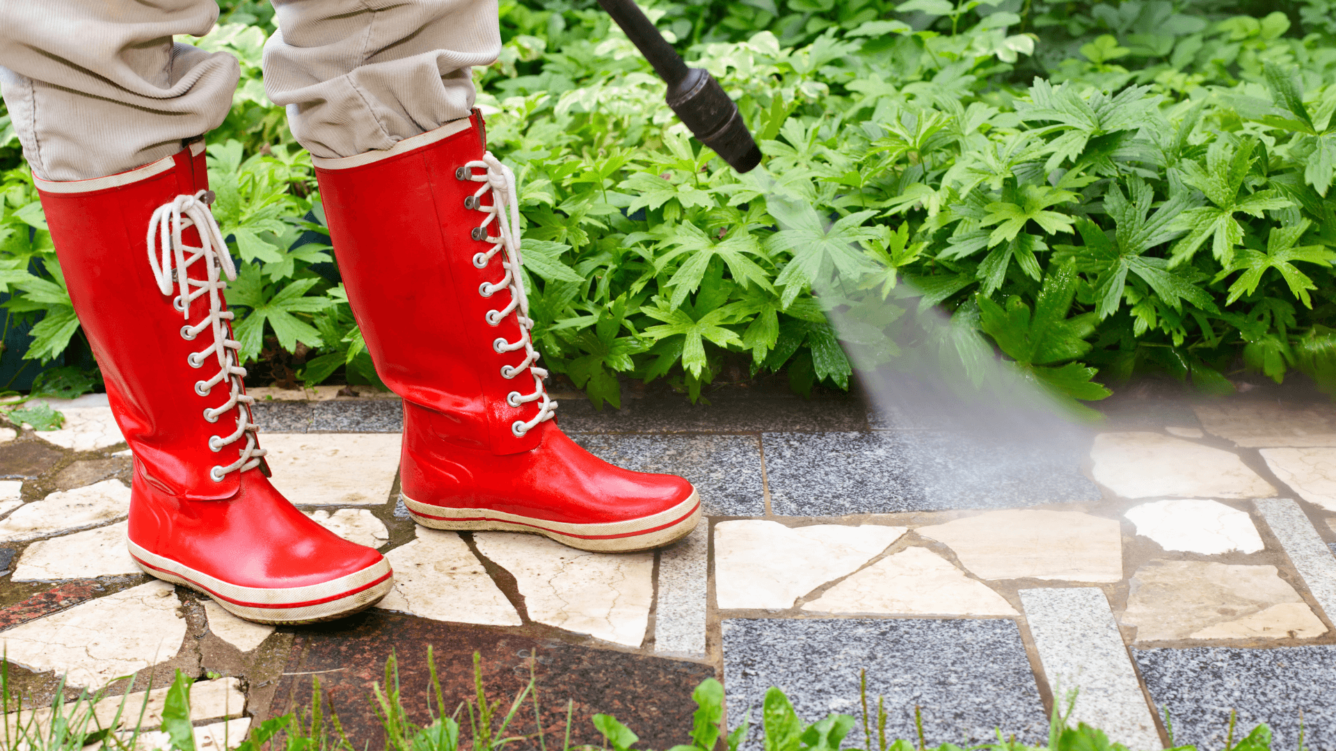 Woman using pressure washer in red boots