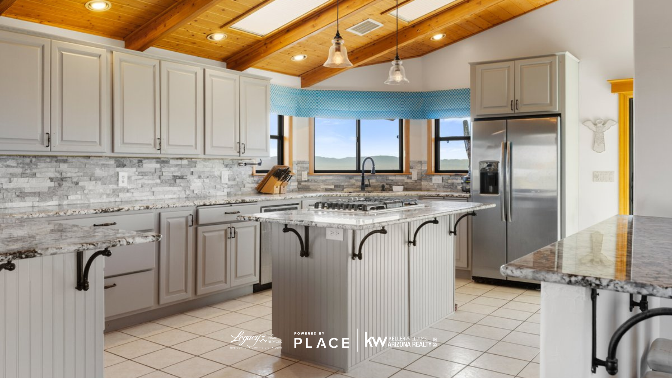 Gourmet kitchen in a Prescott home featuring modern appliances and forest views.