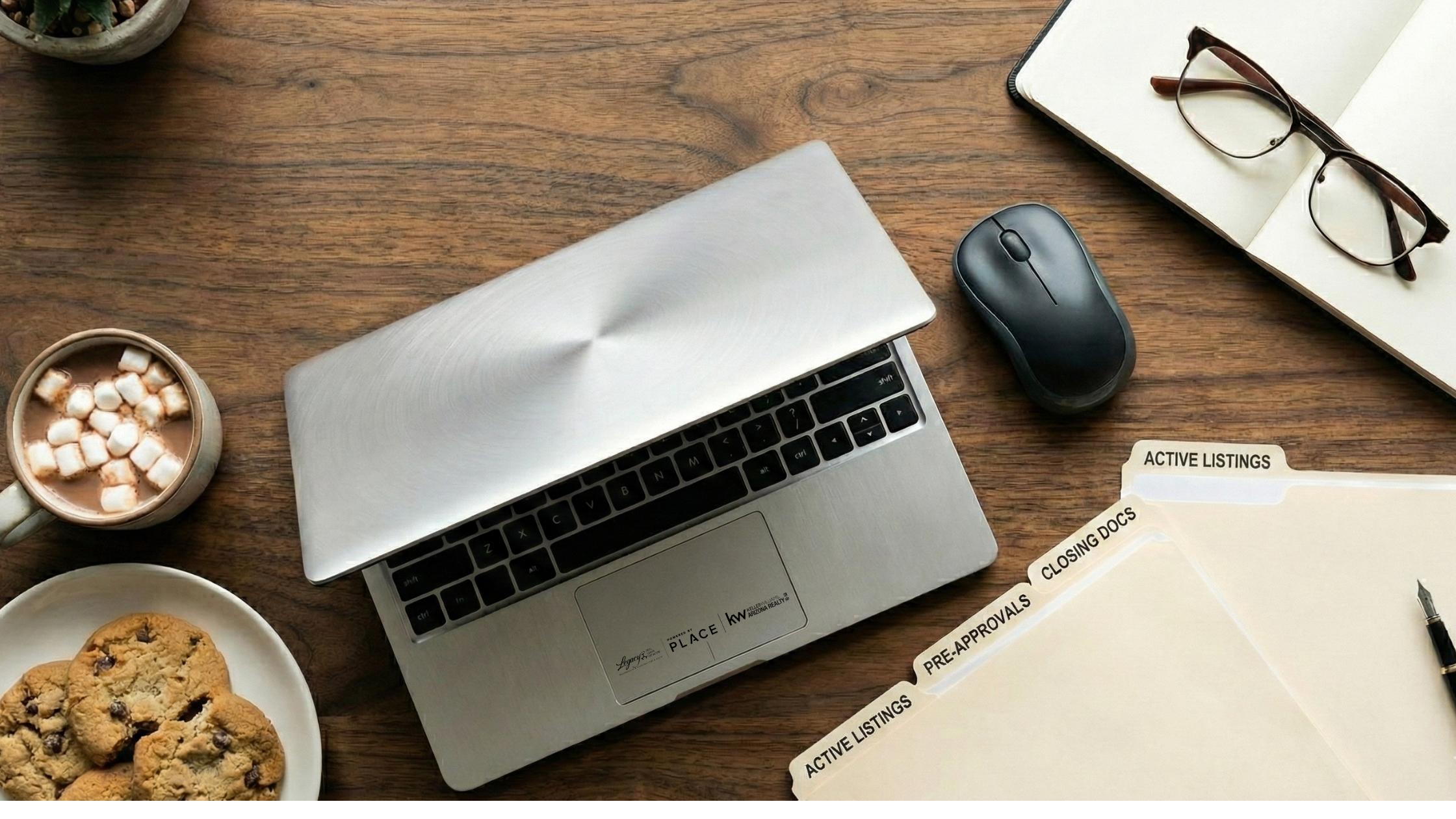 Desktop view of work area with cocoa and cookies