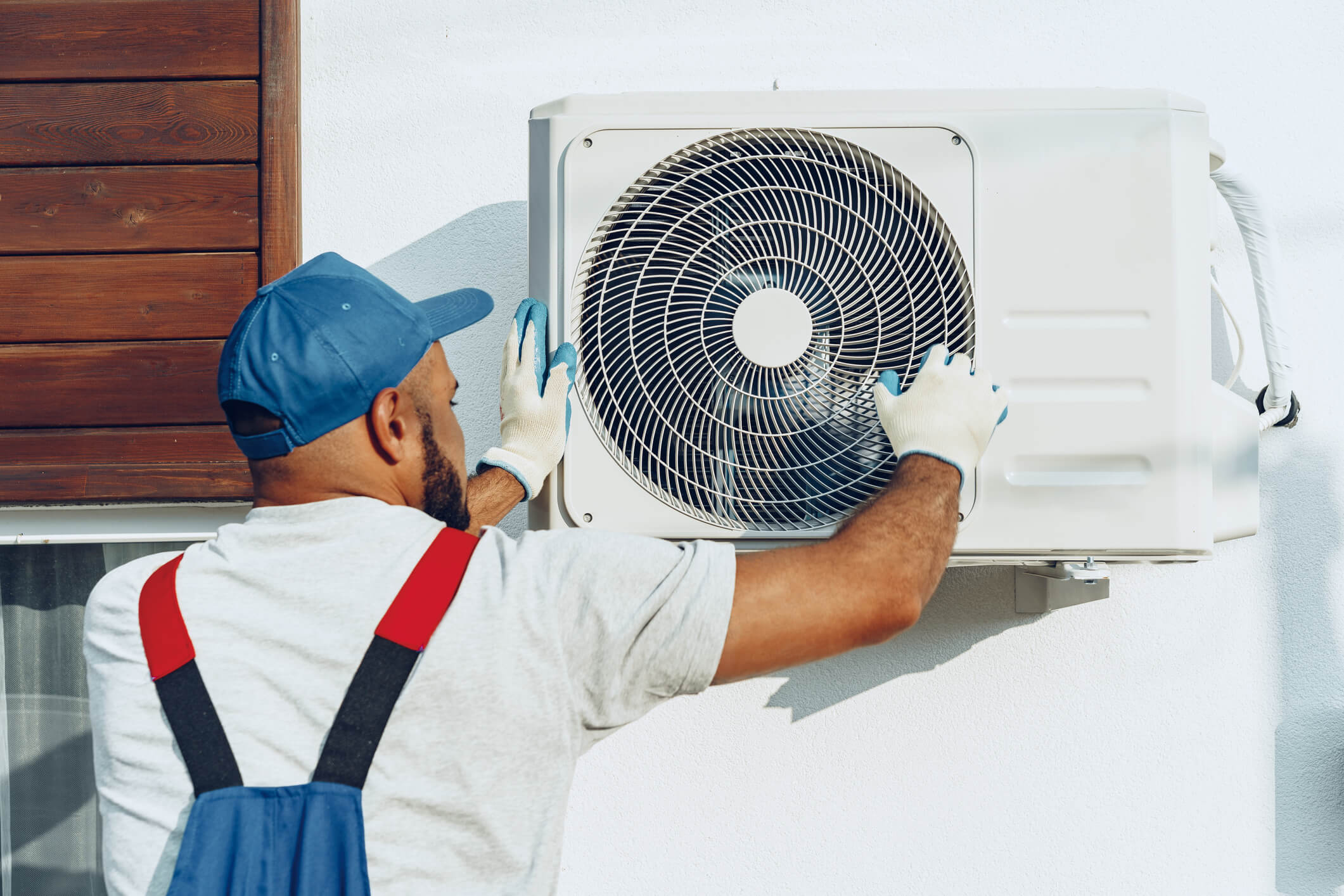 Maintenance worker attending to HVAC machine