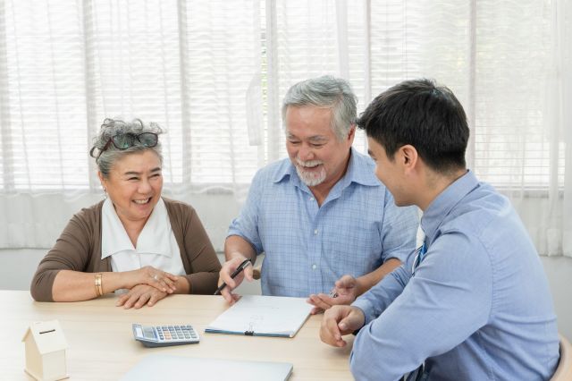 couple signing contract with a realtor