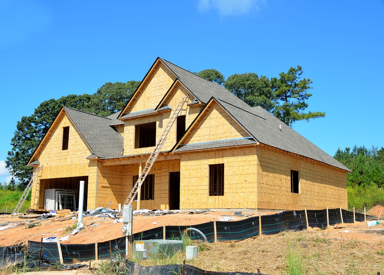 New construction home under development in Central Florida with framing, roof installed, and exterior sheathing visible