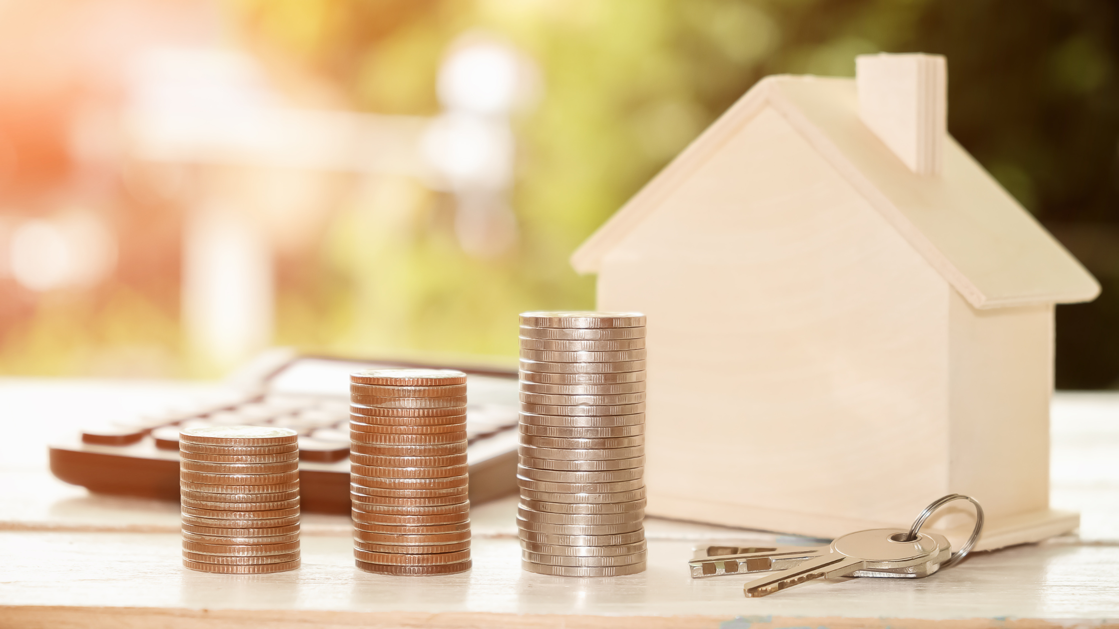 Money, keys and a house figurine