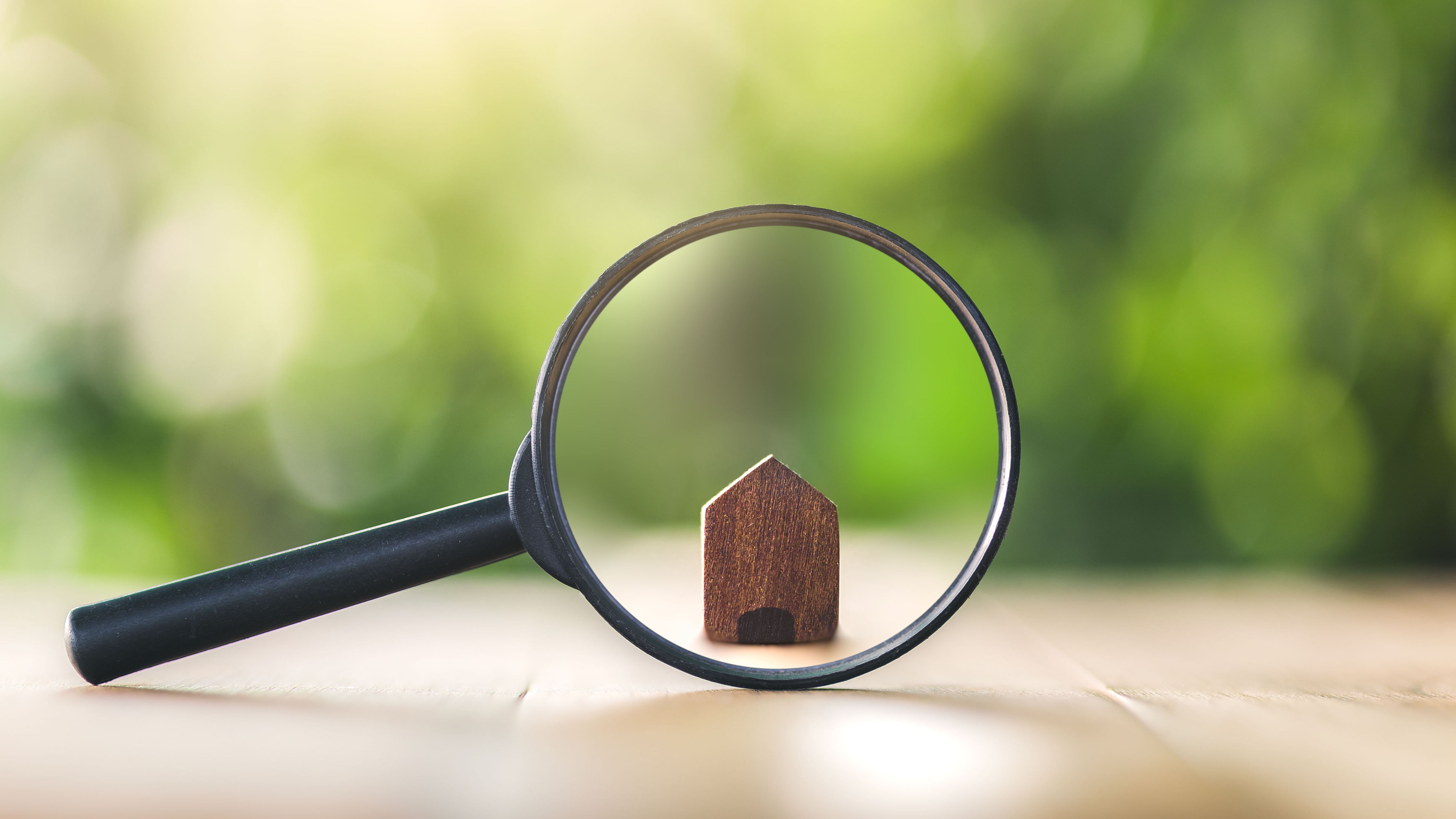 House figure in magnifying glass