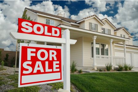Sold sign in front of a suburban home, representing Rochester NY housing market trends in the 2025 real estate update.