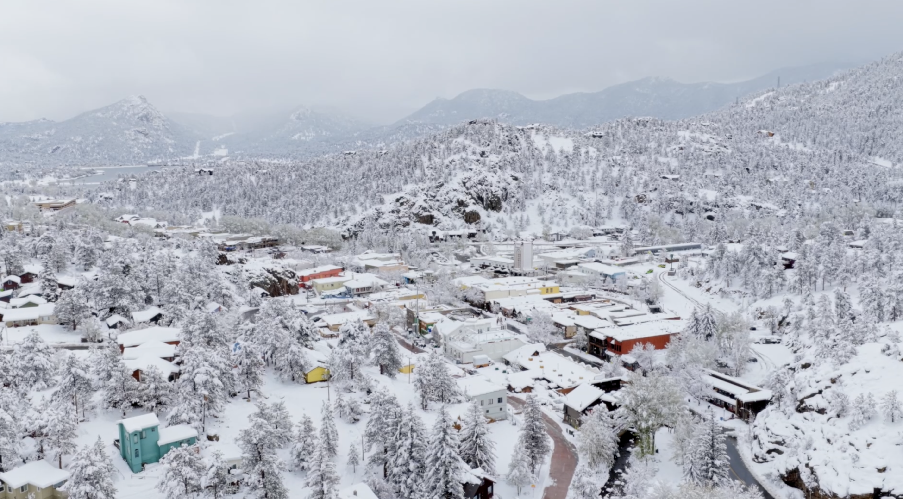 May snowfall covering Estes Park with Rocky Mountain peaks in background