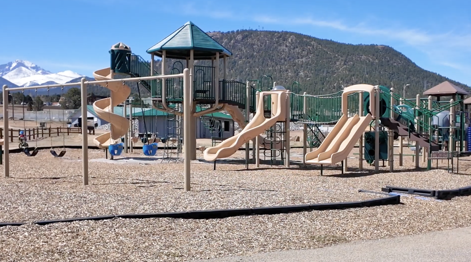 Stanley Park playground with slides, climbing structures, and mountain views in Estes Park Colorado