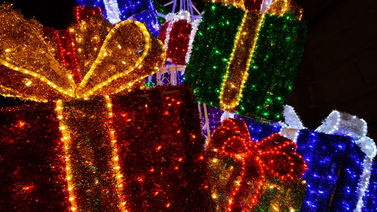 Illuminated handcrafted gift box float with tinsel and rope lights at the Catch the Glow Parade in Estes Park, Colorado
