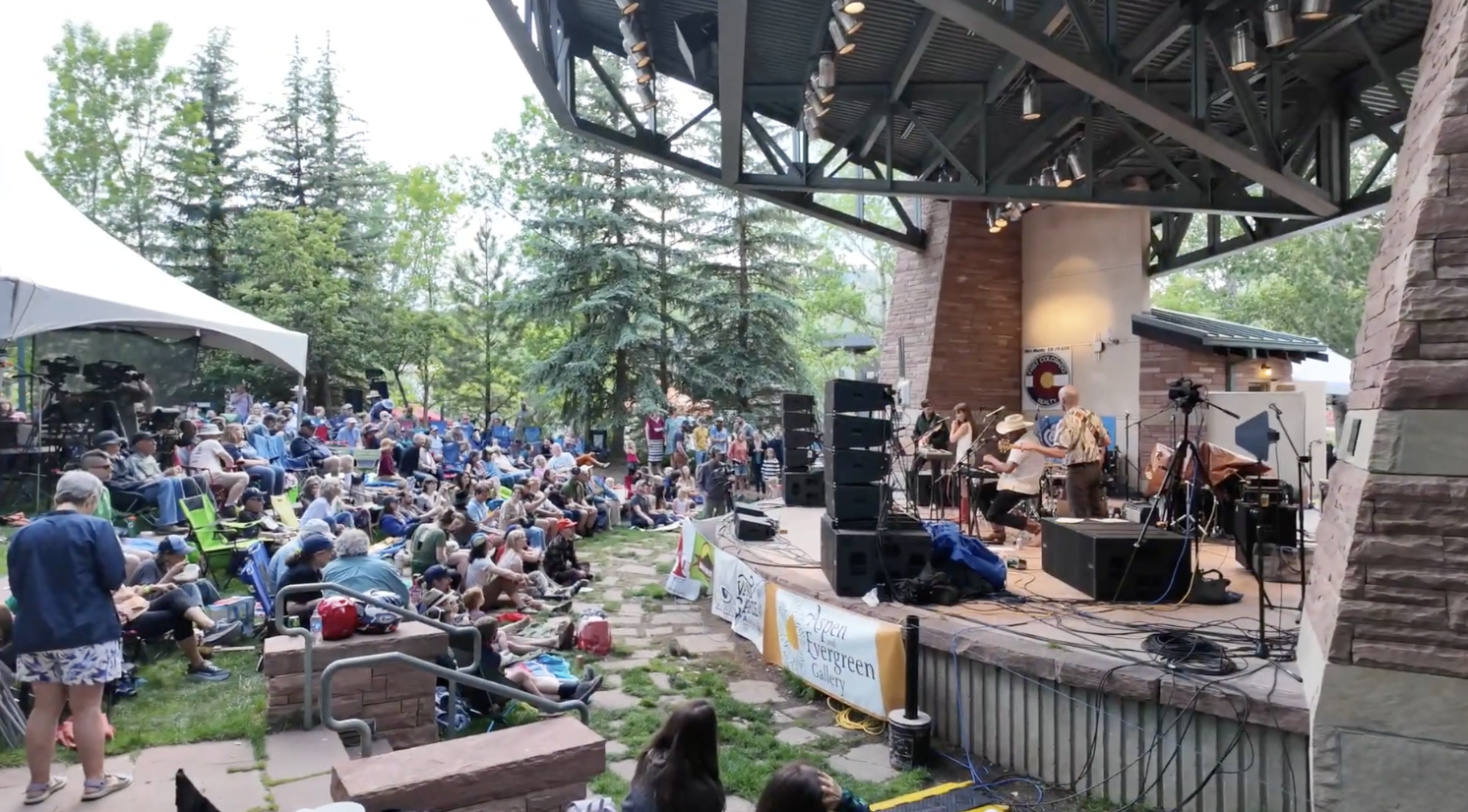 Friends of Folk Festival 2025 at Performance Park in downtown Estes Park with mountain backdrop