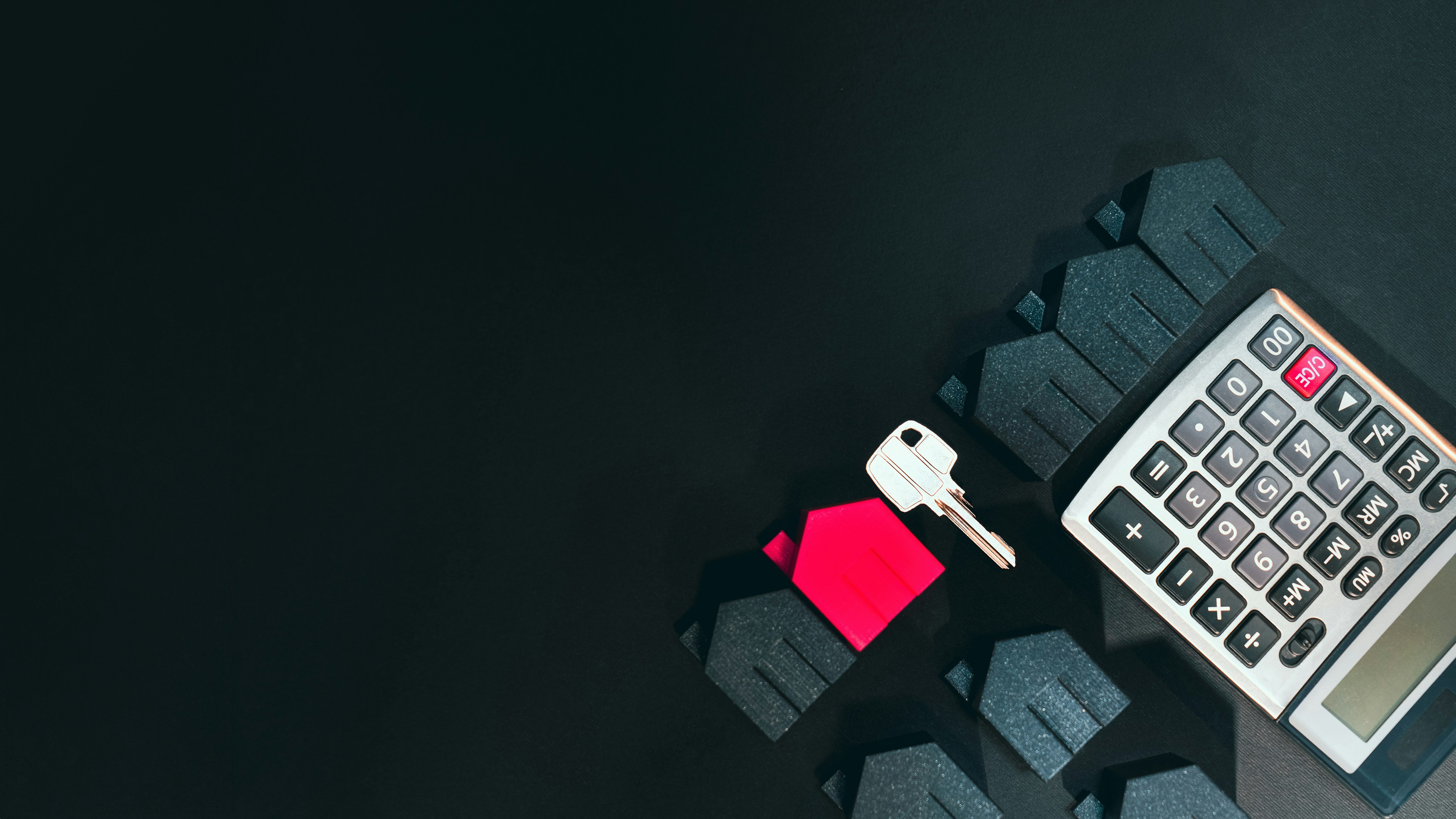 home icons, key, and calculator on black background