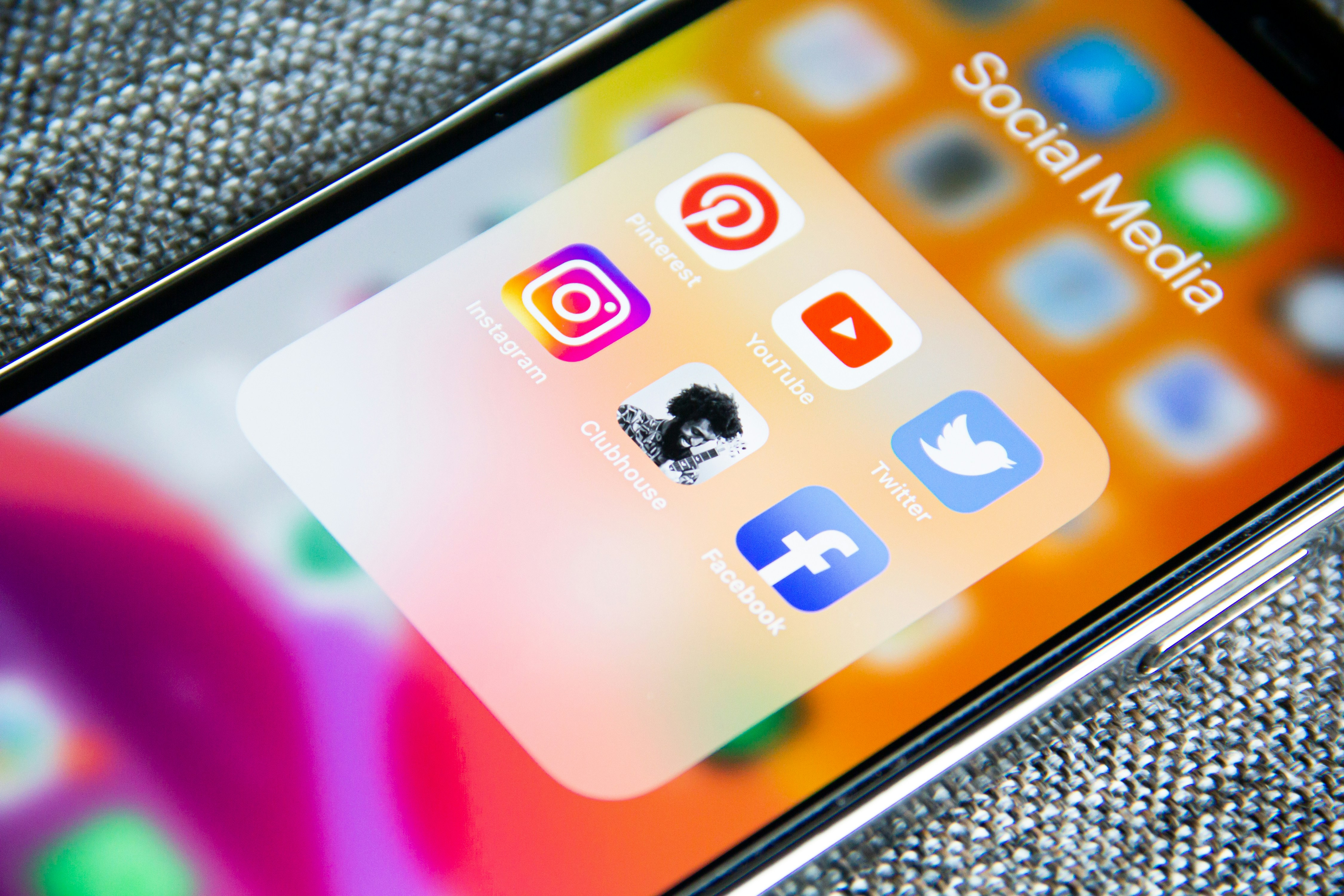 an iphone displays social media app icons facebook instagram pinterest youtube twitter