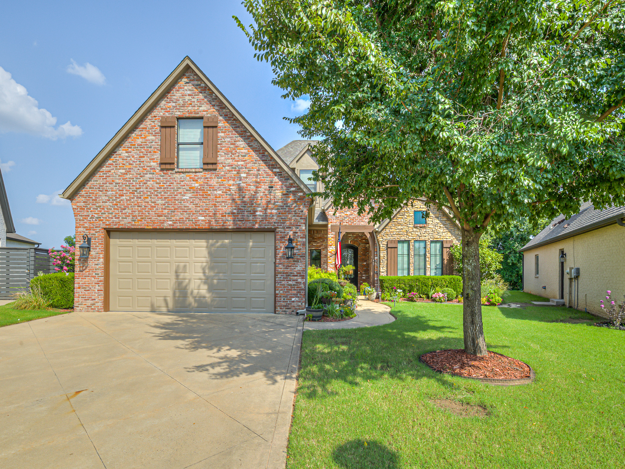 Beautiful front view of 14699 S Gary Avenue, Bixby OK with landscaped yard and spacious driveway