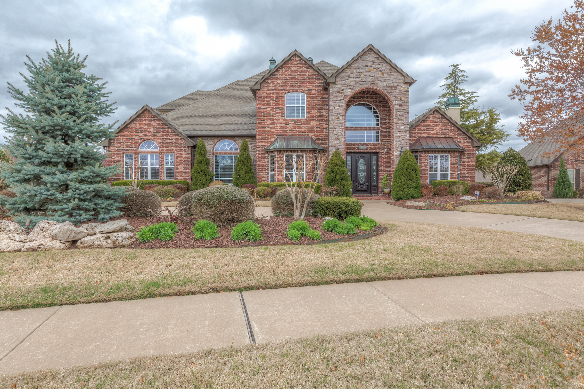 REMARKABLE executive home with flexible floor plan and stunning custom details on a picturesque lot in quiet, well-established neighborhood! The Wolek Group | Tulsa Realtor header image.