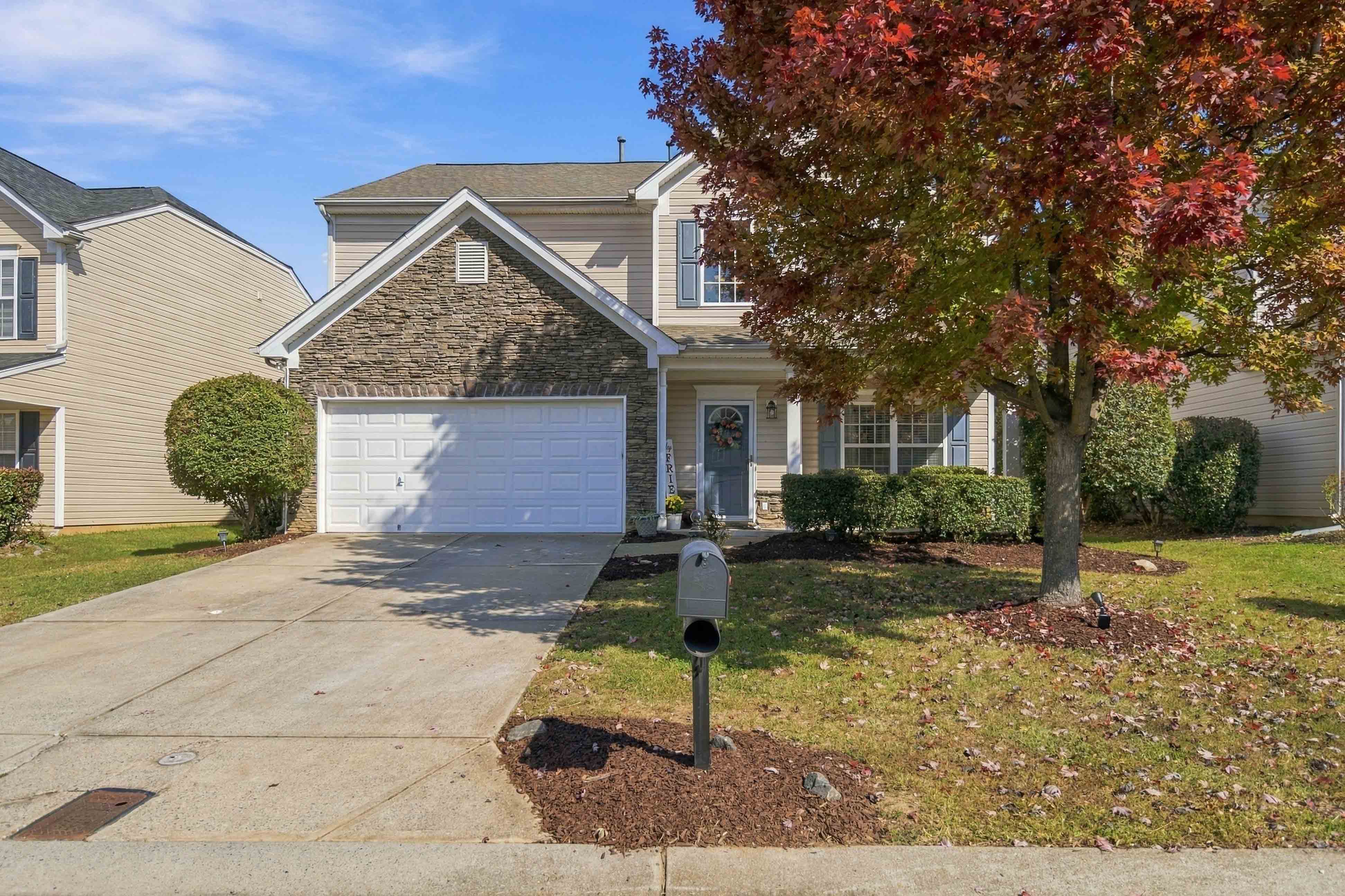 Two-story stone and vinyl home with two-car garage at 1442 Haverford Rd NW in Moss Creek, Concord NC