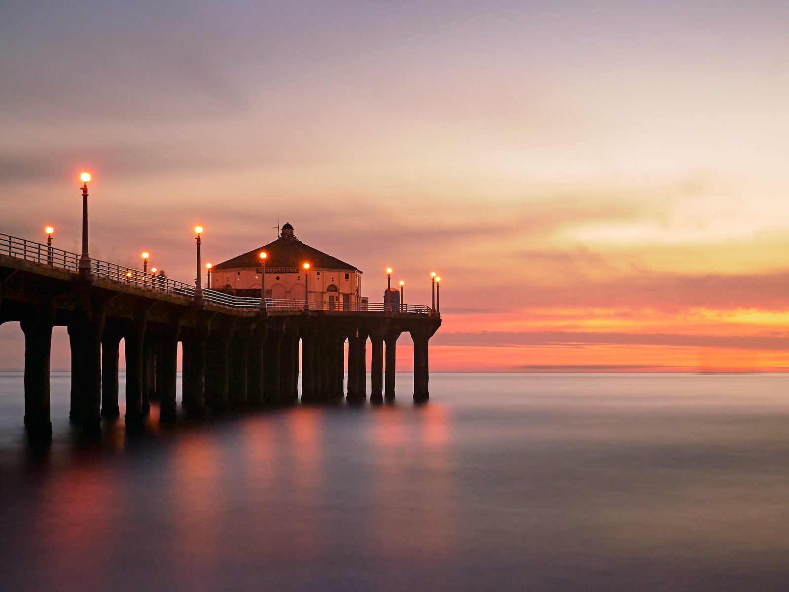 The Manhattan Beach Pier lit up at sunset