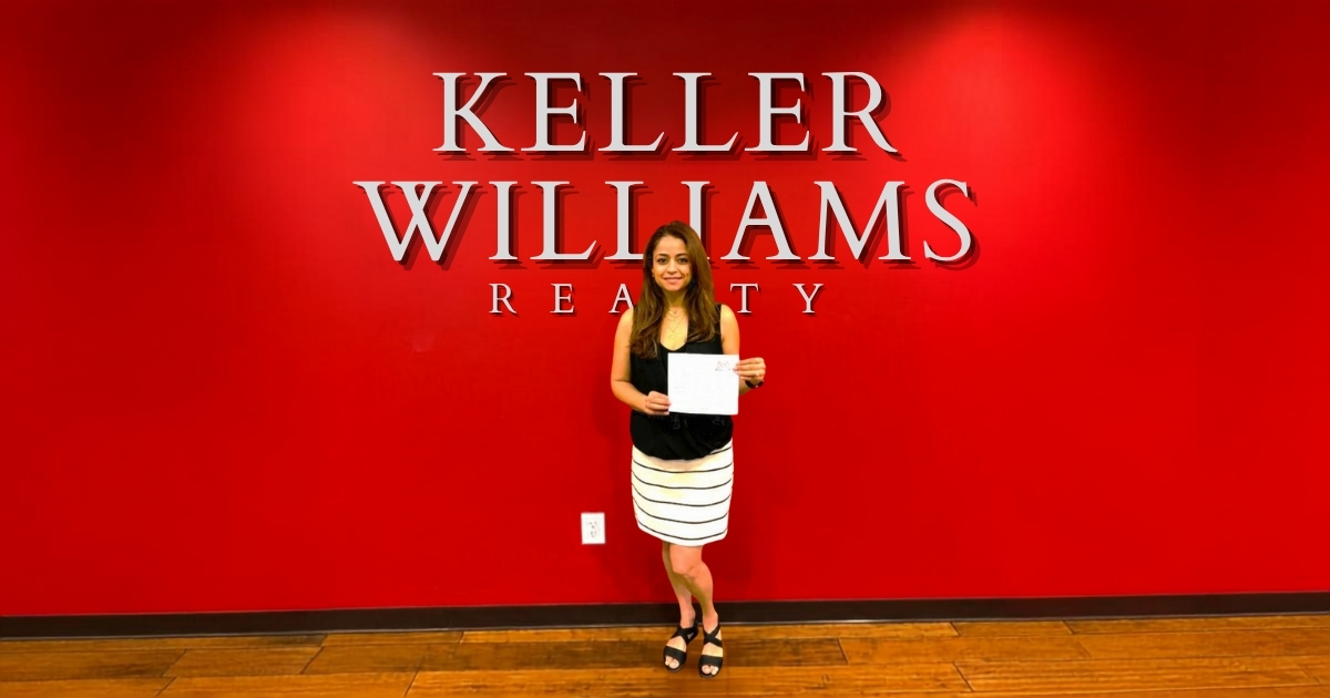Leda Othman, a real estate listing agent in Spartanburg and Greenville, standing in front of the Keller Williams Realty office.