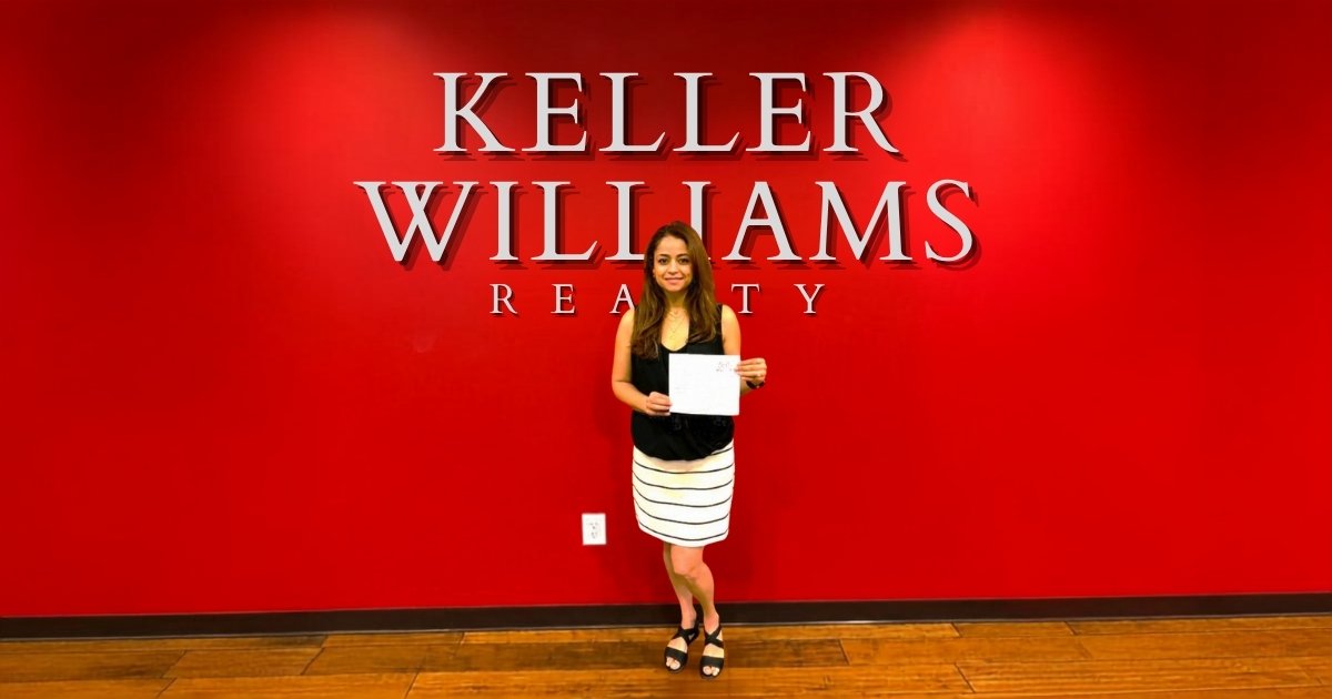 Leda Othman, a real estate listing agent in Spartanburg and Greenville, standing in front of the Keller Williams Realty office.