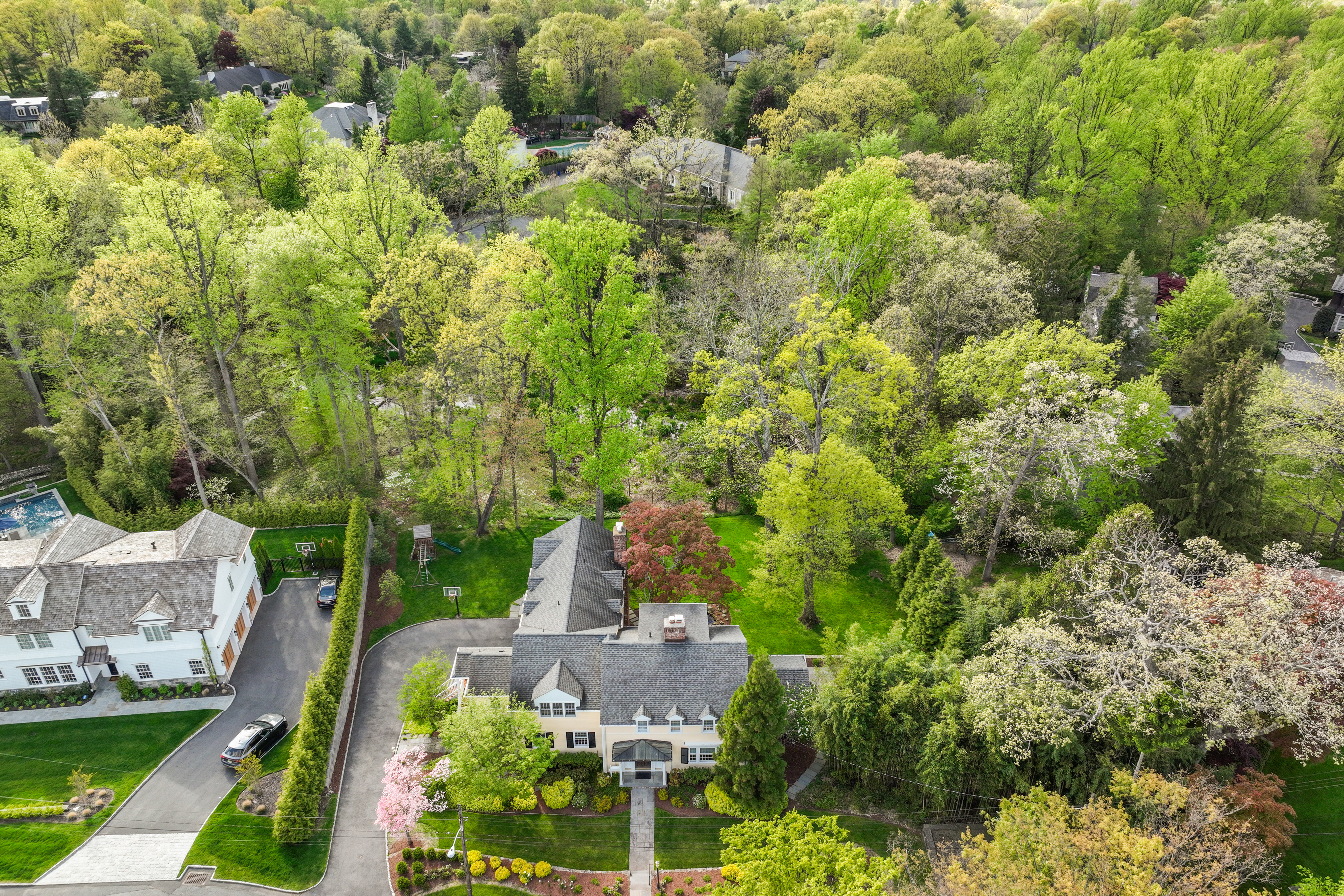Aerial view of a beautifully maintained New Jersey luxury home previously listed by the LuxeLife Group, showcasing the property's spacious layout and attractive neighborhood setting.